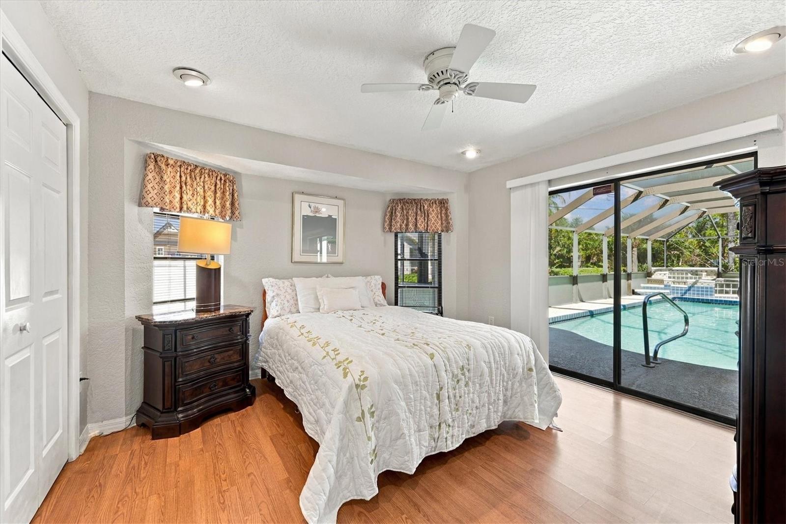 Bedroom with pool access and walk in closet. - 175 NORMAN ST, PORT CHARLOTTE