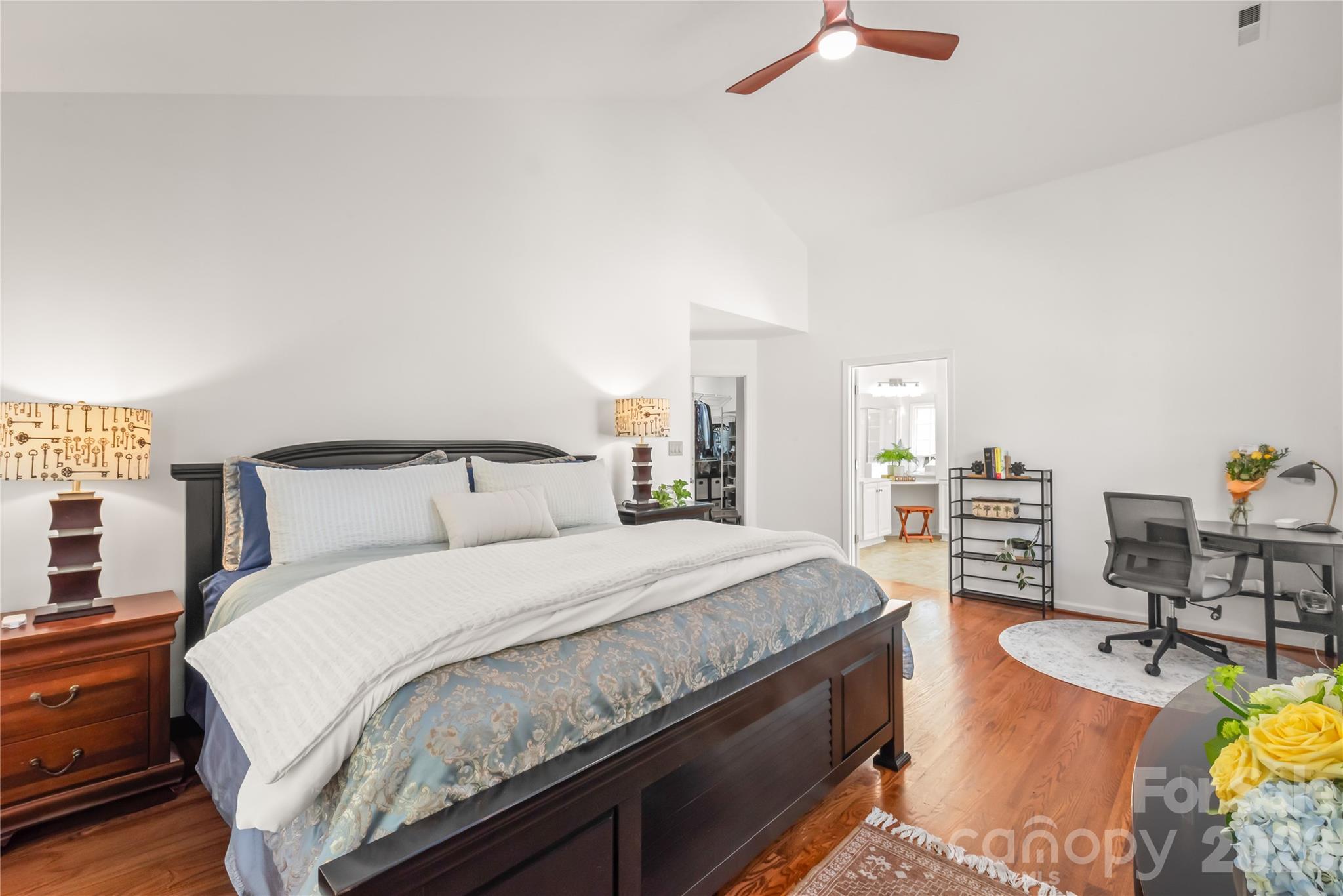 Spacious primary suite features soaring vaulted ceilings, abundant natural light, and a serene, restful atmosphere designed for unwinding. - 11024 Stonepath Lane, Charlotte