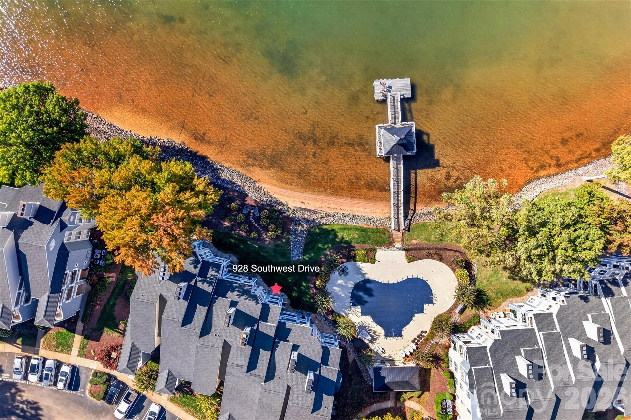 Aerial view of the gorgeous community pool, pier, and waterfront dock! Just steps from your patio, making it easy to enjoy the best of Lake Norman living! - 928 Southwest Drive, Davidson