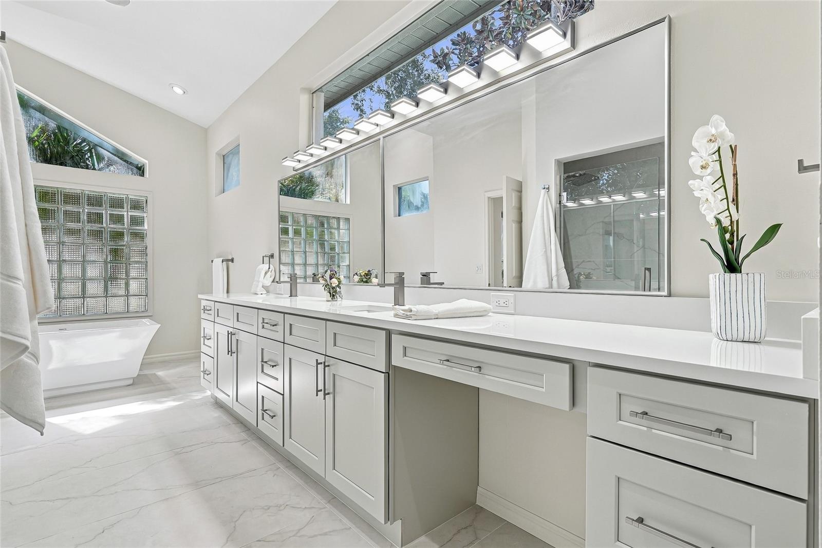 Modern and sleek primary bathroom vanity with make up area. - 1101 DARLINGTON OAK DR NE, ST PETERSBURG