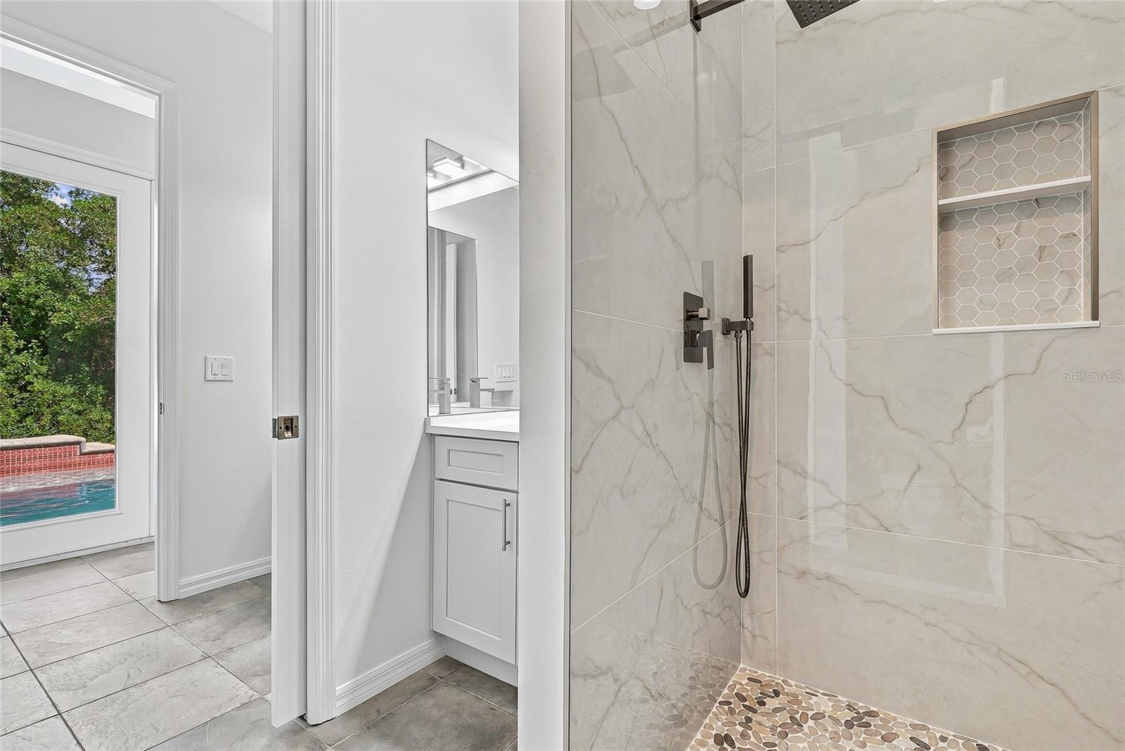 Full bath and half bath accessible by the pool. - 1101 DARLINGTON OAK DR NE, ST PETERSBURG