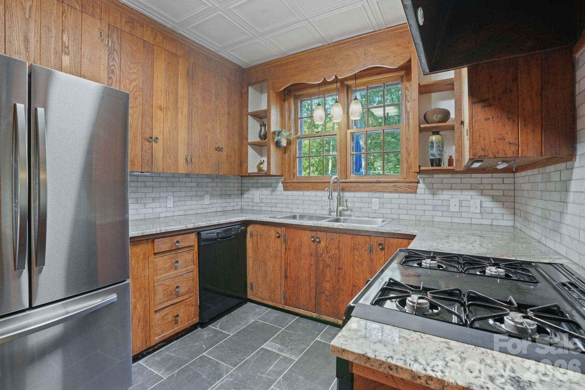 Renovated Kitchen, Wormy Chestnut Cabinetry and Stove Hood, Granite Tops, Tile-Stone Floor, Stainless Appliances and Sink, Gas Stove, Views to the serenity of the Back Spaces - 319 N Zion Street, Landis