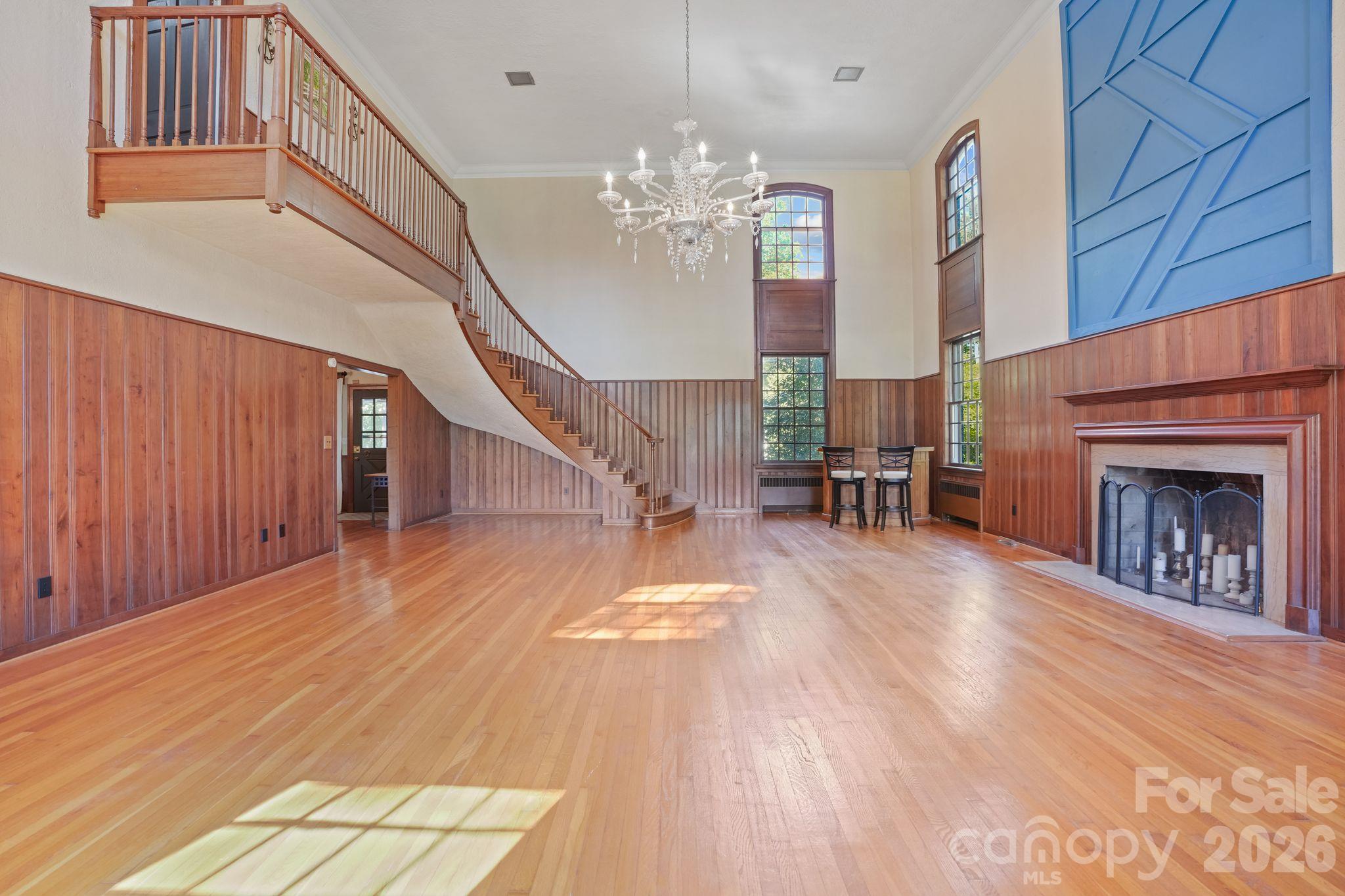 Grand Living Room, 3/4" Thick, Wood Panels Surround, Acoustic walls above, Staircase Ascends from Upstairs, Fireplace, Floor to Ceiling Storm Windows, Hardwood Floor - 319 N Zion Street, Landis