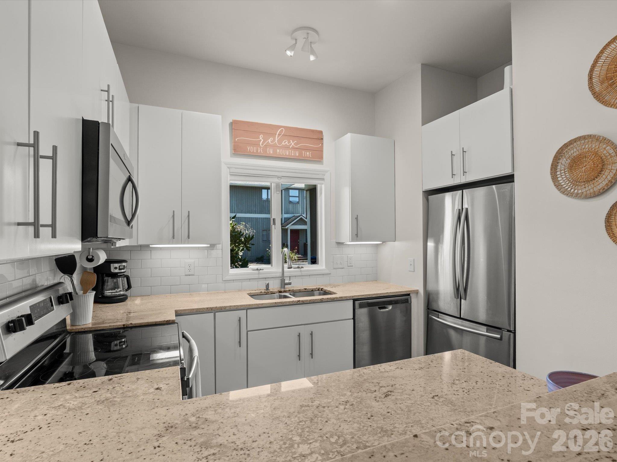 Under cabinet lighting brightens the kitchen - 524 Windswept Drive, Asheville