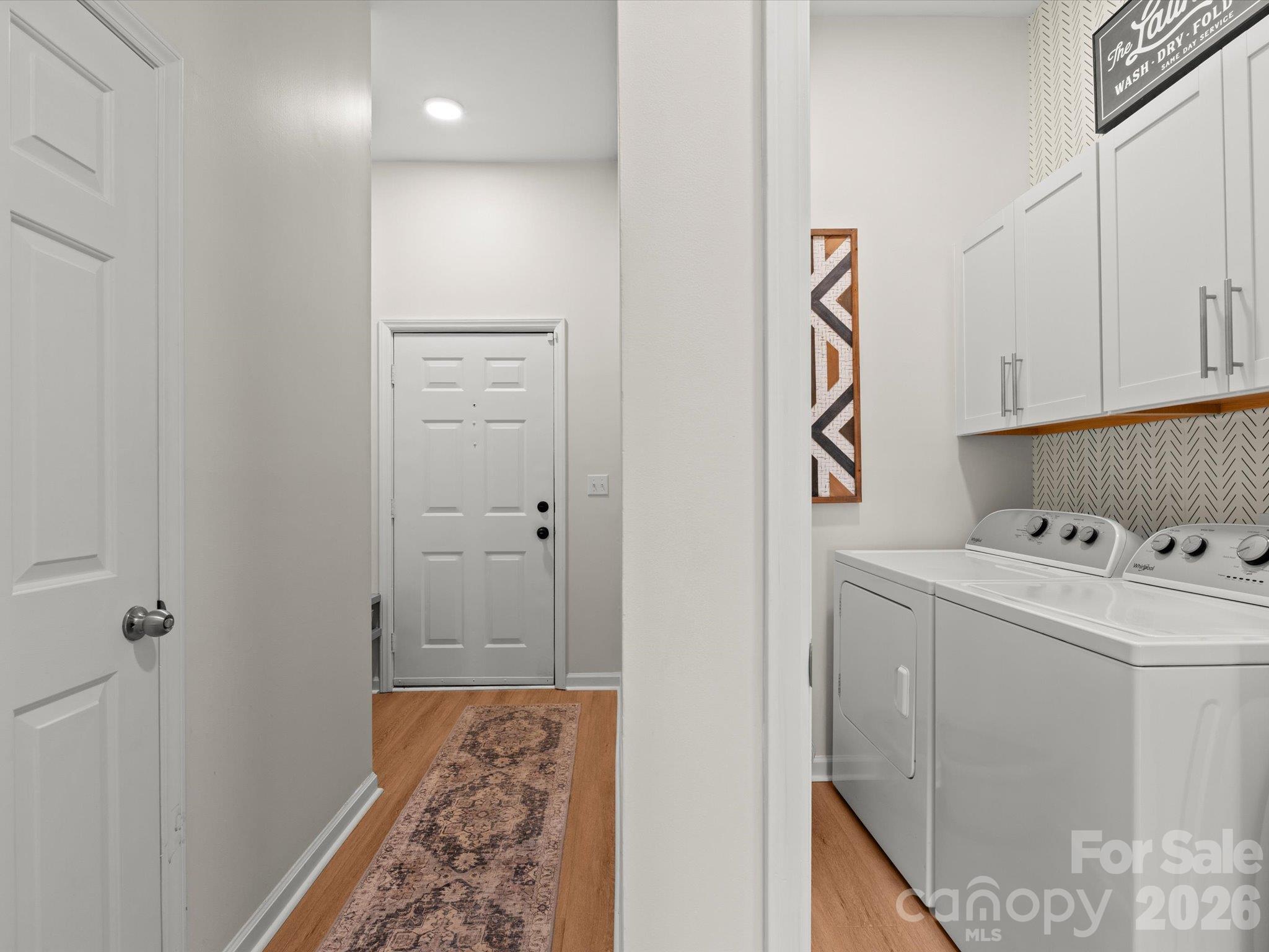 Looking from the hallway toward the entry on the left and the laundry room - 524 Windswept Drive, Asheville