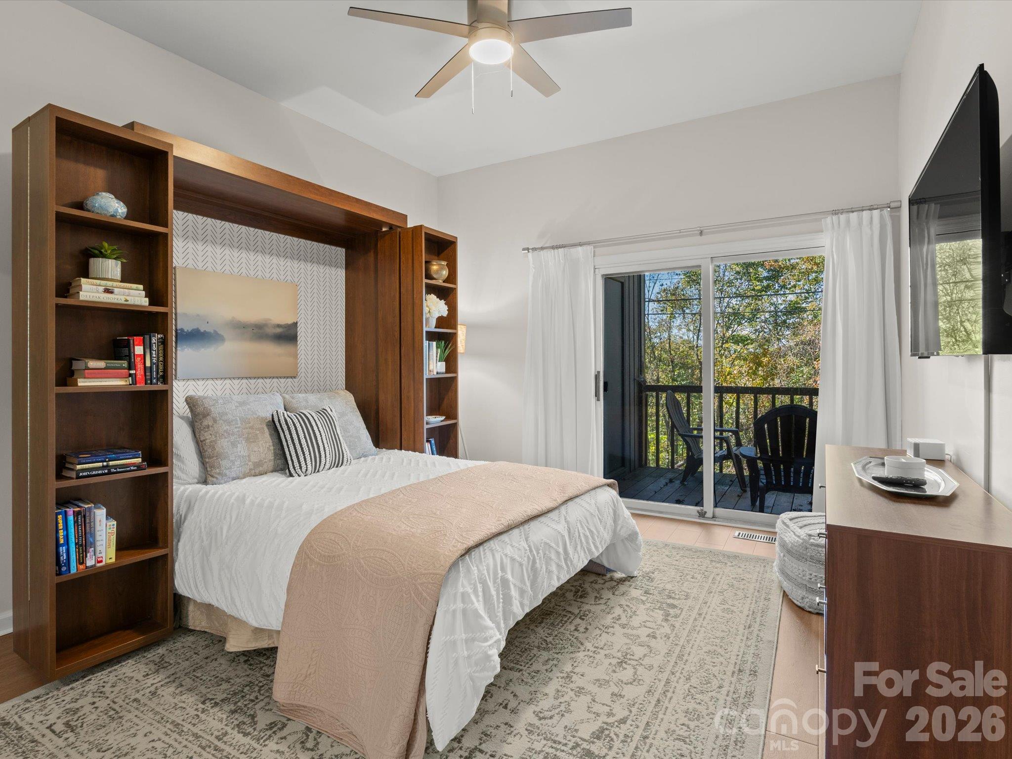 A sliding glass door brings in natural light and allows access to the deck - 524 Windswept Drive, Asheville