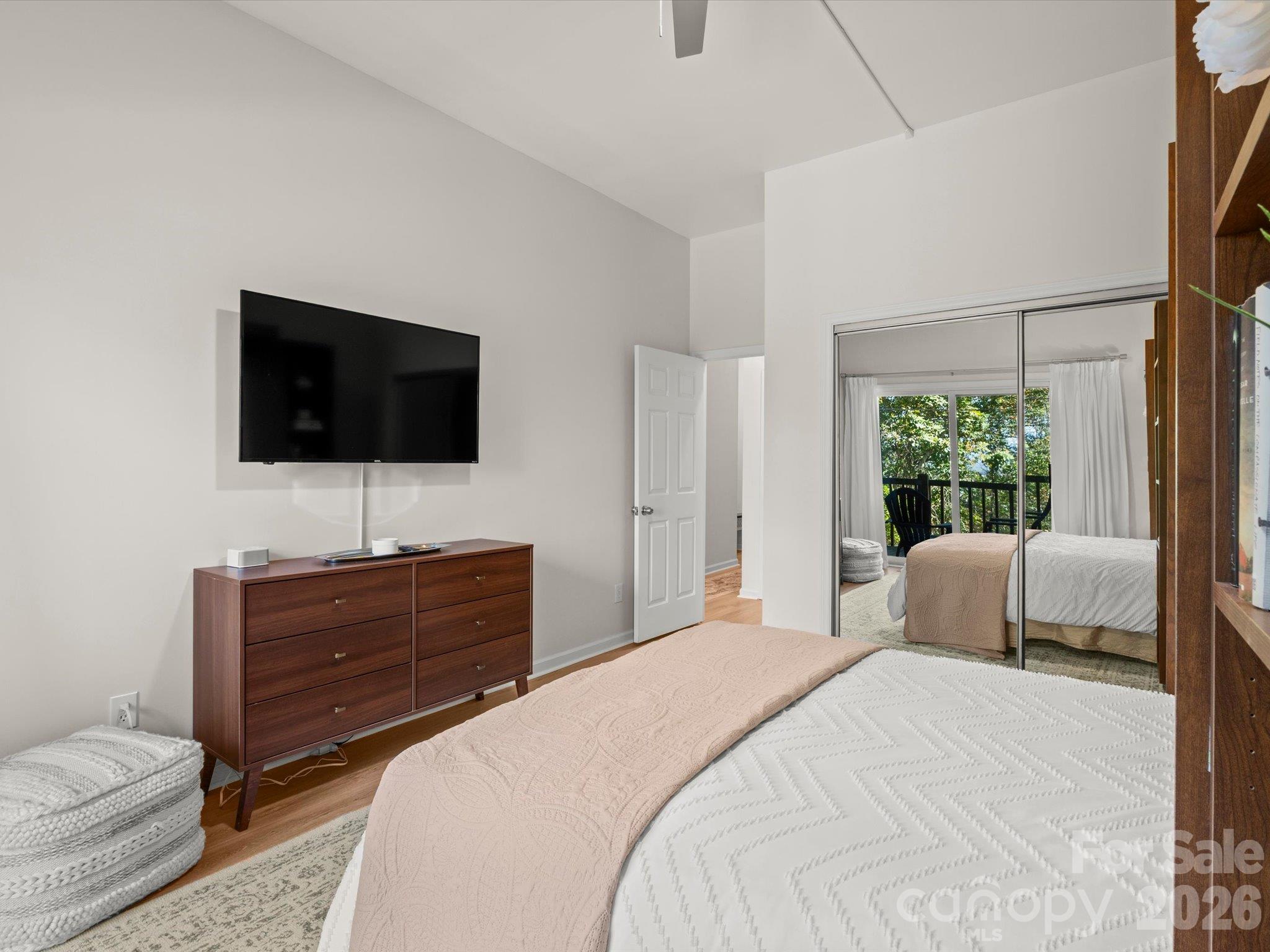 Mirrored closet doors reflect light throughout the space - 524 Windswept Drive, Asheville