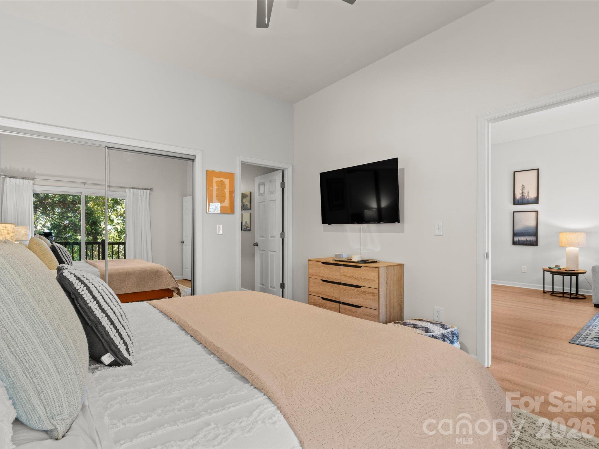 Primary bedroom, with matching mirrored closet doors - 524 Windswept Drive, Asheville