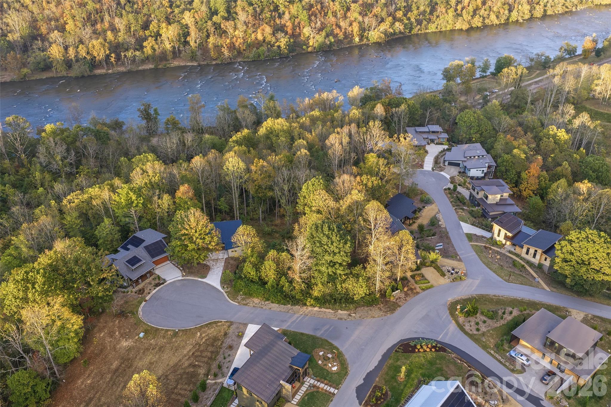 Aerial of the property and nearby homes against the backdrop of the French Broad - 404 Blue Mind Way, Asheville