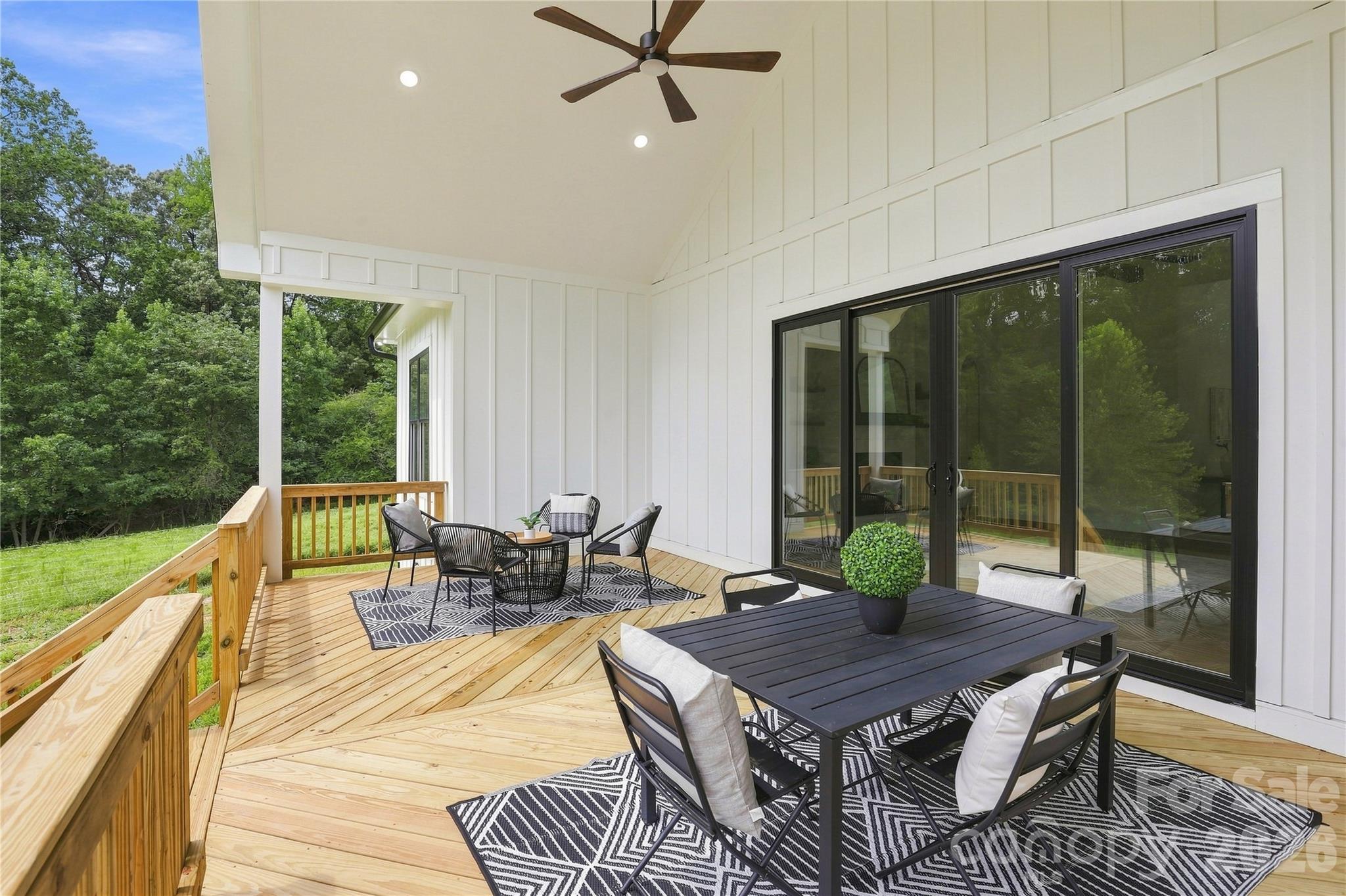 Covered back deck included with vault, ceiling fan, exterior black windows - 509 Simpson Road, Locust
