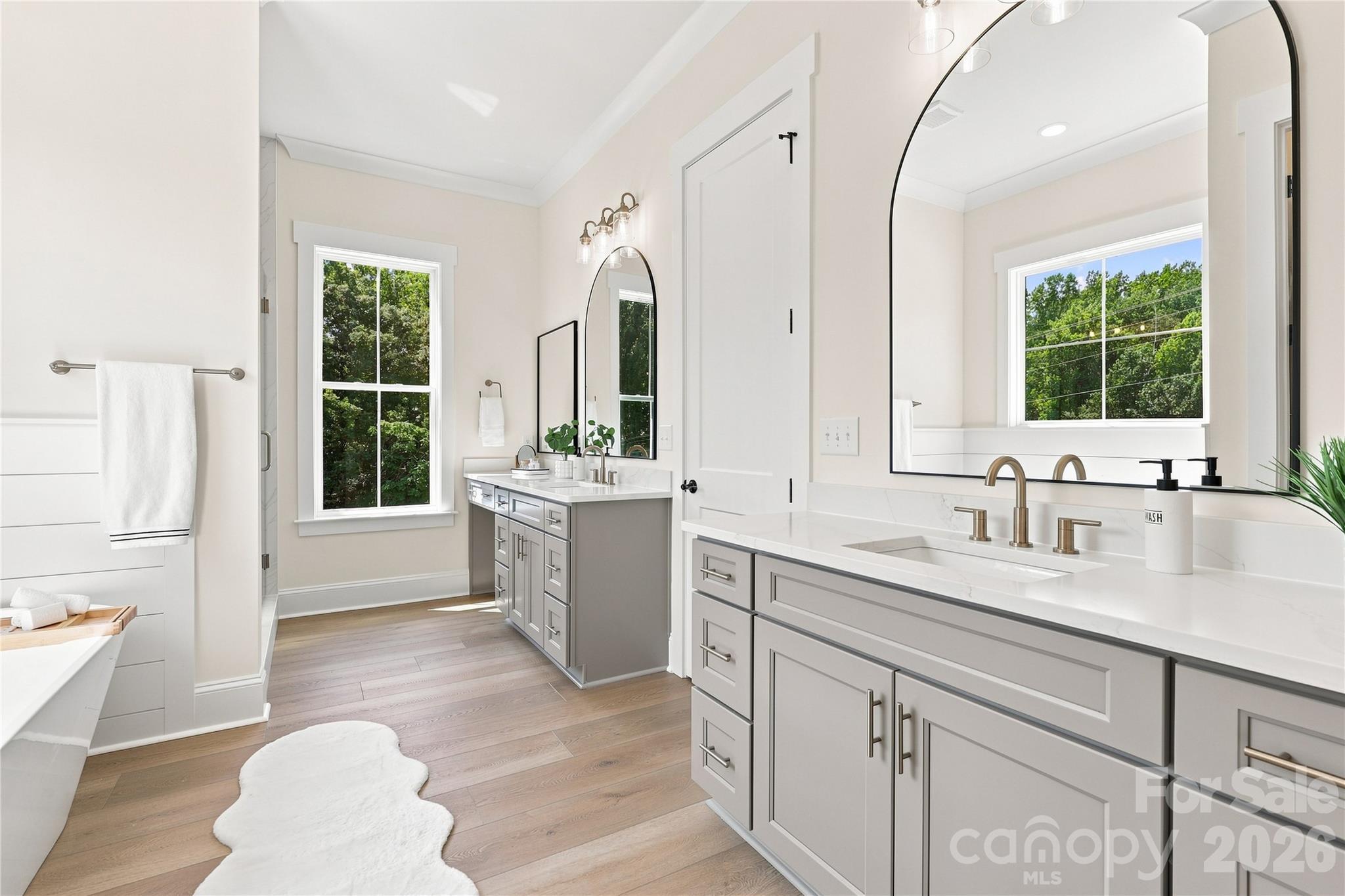 Primary bath with two vanities, make-up area, arched mirrors - 509 Simpson Road, Locust