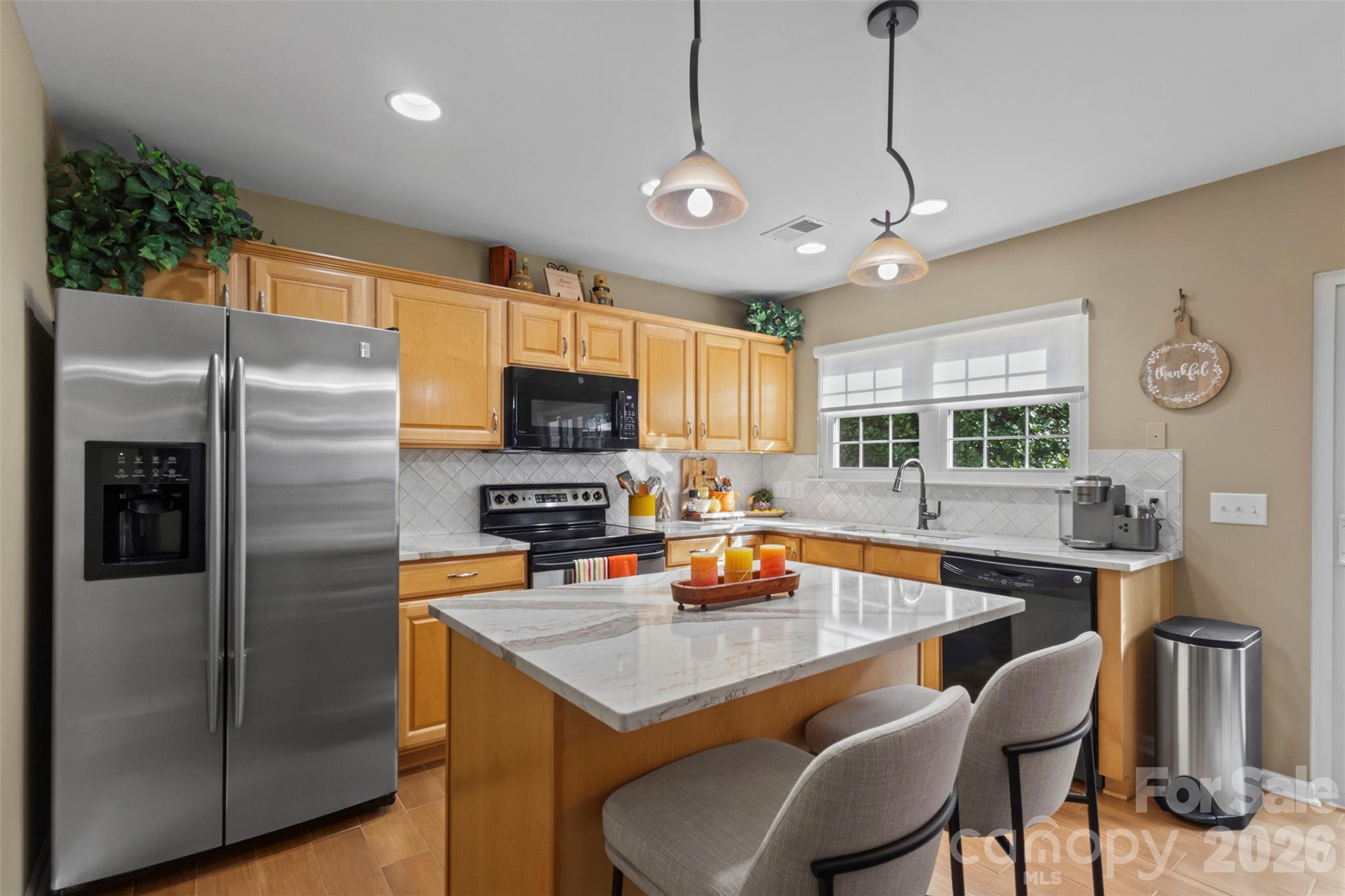 Recent upgrades include quartz countertops, tile backsplash, and single bowl sink with Brizo faucet - 18912 Harbor Cove Drive, Cornelius