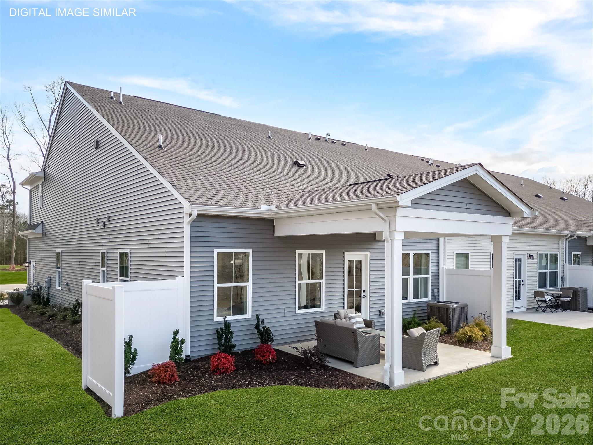 Optional covered rear patio with private divider is ideal for relaxing or entertaining with low-maintenance outdoor living. - 11174 Emerson Landing Drive, Charlotte