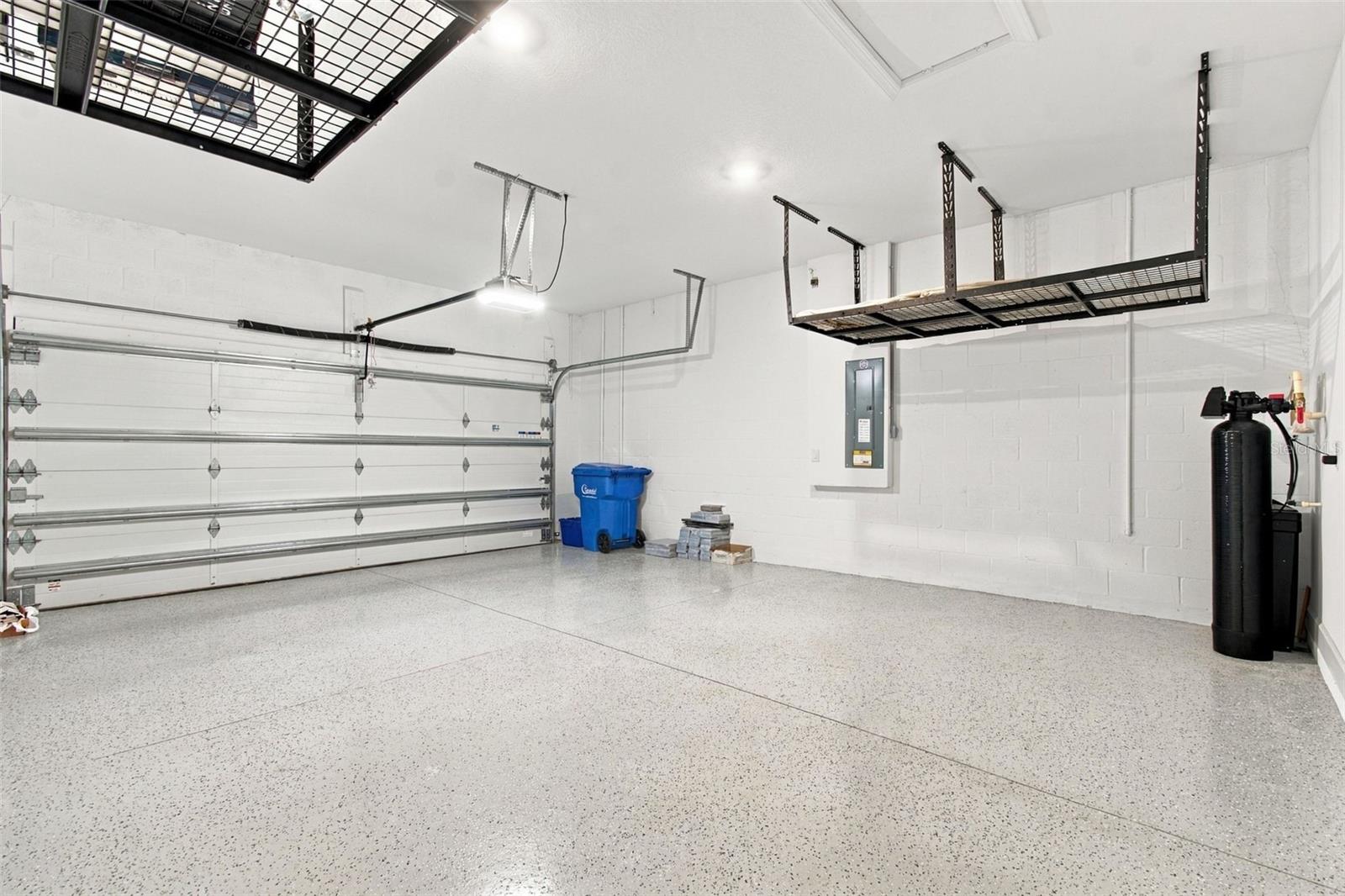 The garage has the four foot extension option, epoxied floors and built-in storage racks - 29749 CASSINO CT, WESLEY CHAPEL