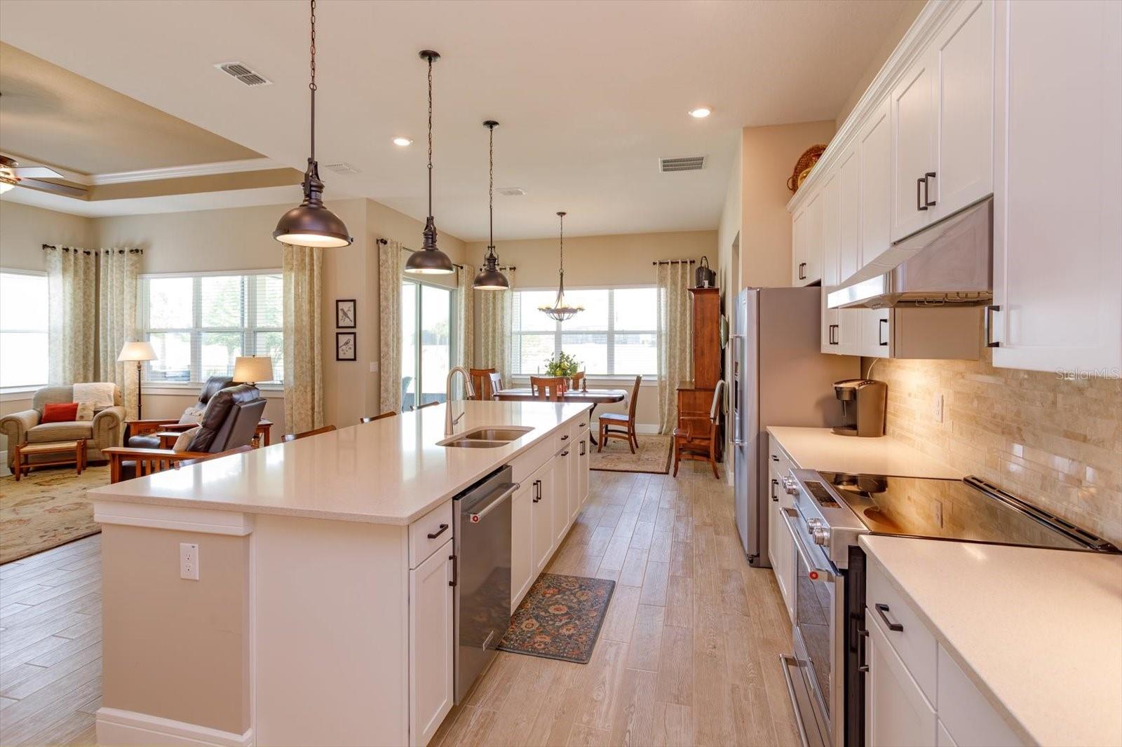 Open Kitchen, Living and Dining Areas with Golf Course Views - 5663 SW 92ND AVENUE RD, OCALA