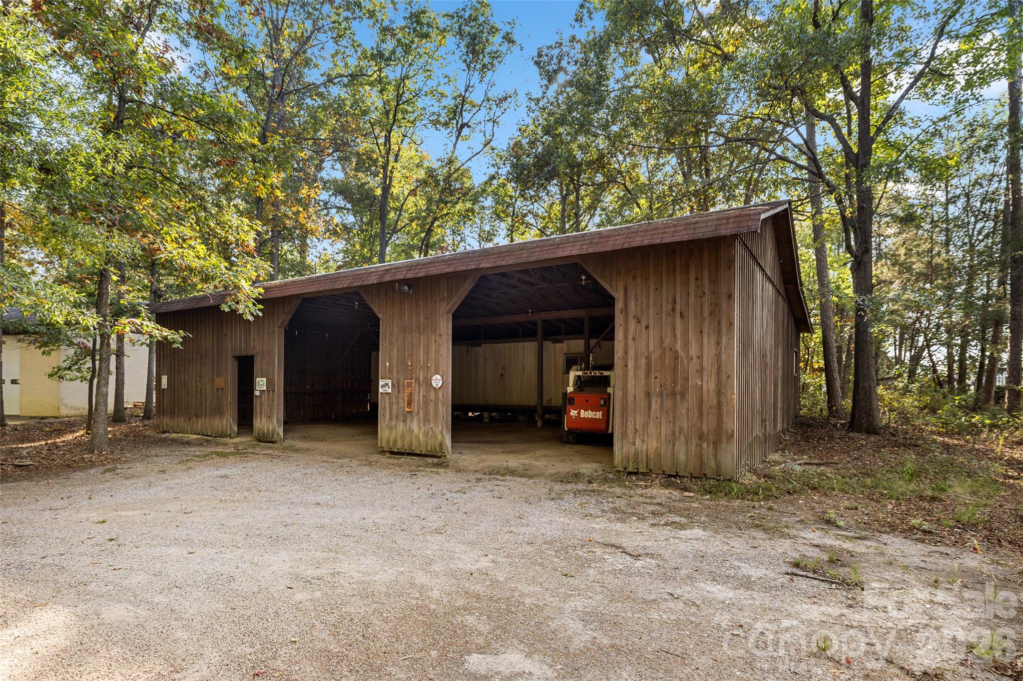 but wait! there is MORE...another covered Bldg with a mobile home under cover... think of the options  you could do with this space.  (SkidStear not included) - 2415 Hargette Road, Monroe
