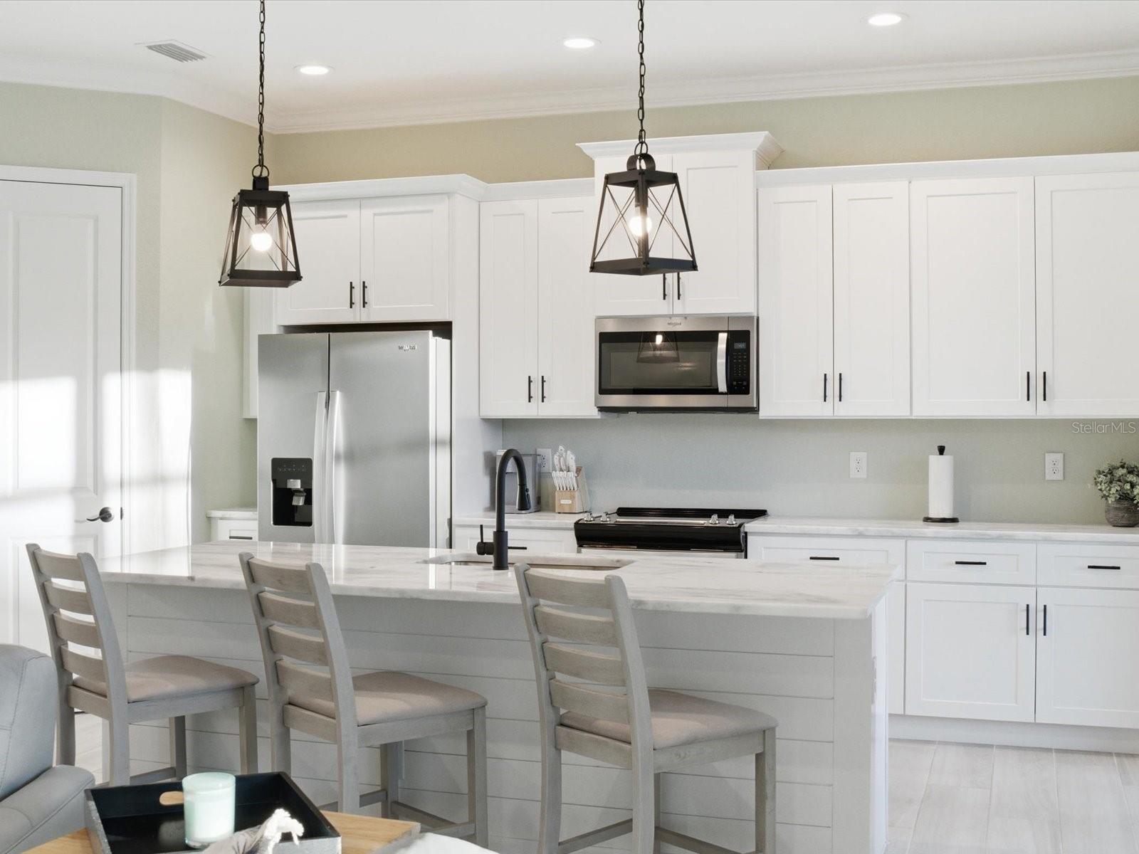 Kitchen island is accented with shiplap - 149 LONG MEADOW LN, ROTONDA WEST