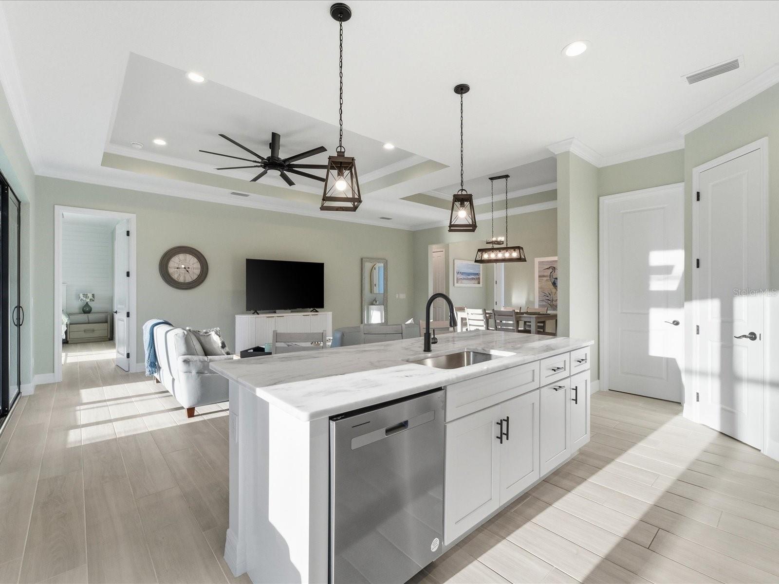 The gorgeous granite topped working island overlooks the Living Room for fantastic entertainment space - 149 LONG MEADOW LN, ROTONDA WEST