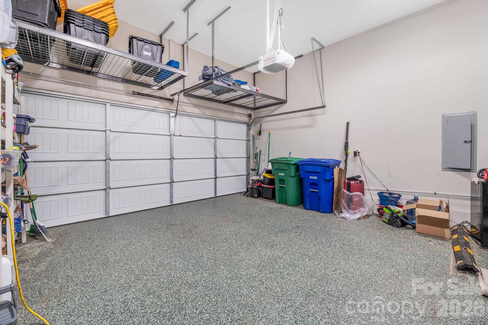 Garage on main level with storage and epoxy floor - 50 Rose Creek Road, Leicester