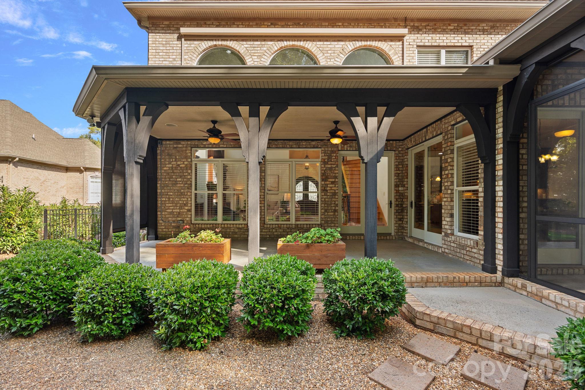 The layout effortlessly maximizes the Carolinas' best seasons. You have the luxury of choosing between two equally incredible  outdoor spaces to relax: a breezy screened porch or a tranquil covered veranda overlooking the backyard. - 108 Lazenby Drive, Fort Mill