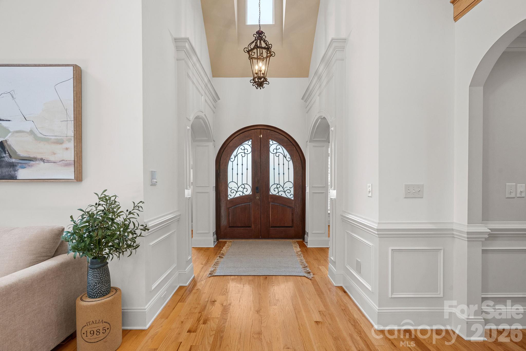 Step through the solid wood double doors into a gracious entry hall anchored by rich hardwoods - 108 Lazenby Drive, Fort Mill