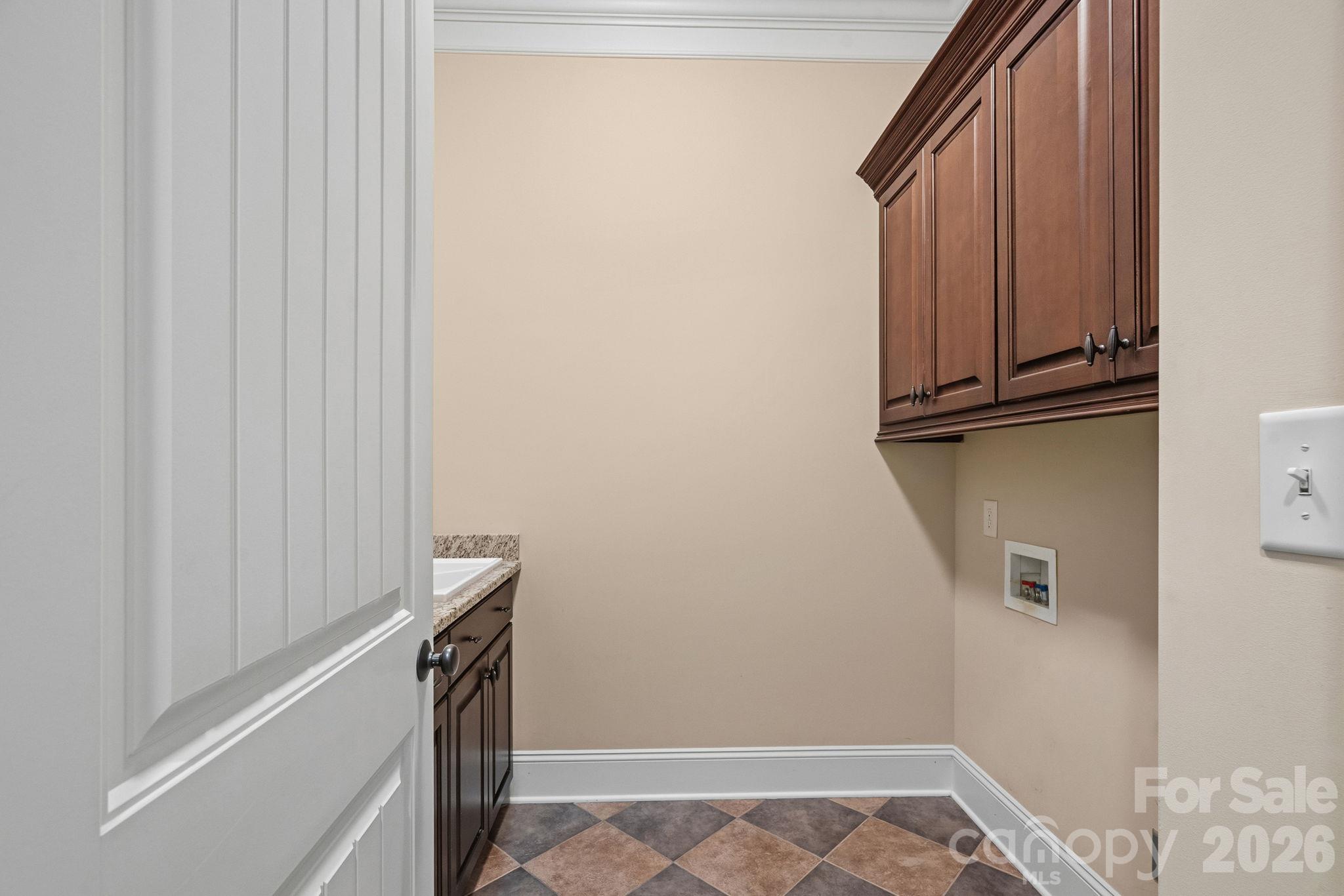 Main-level laundry room cabinetry - 108 Lazenby Drive, Fort Mill