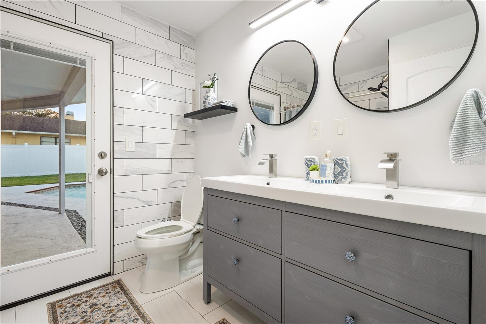 GUEST BATH WITH POOL ACCESS - 3222 WESSEX WAY, CLEARWATER