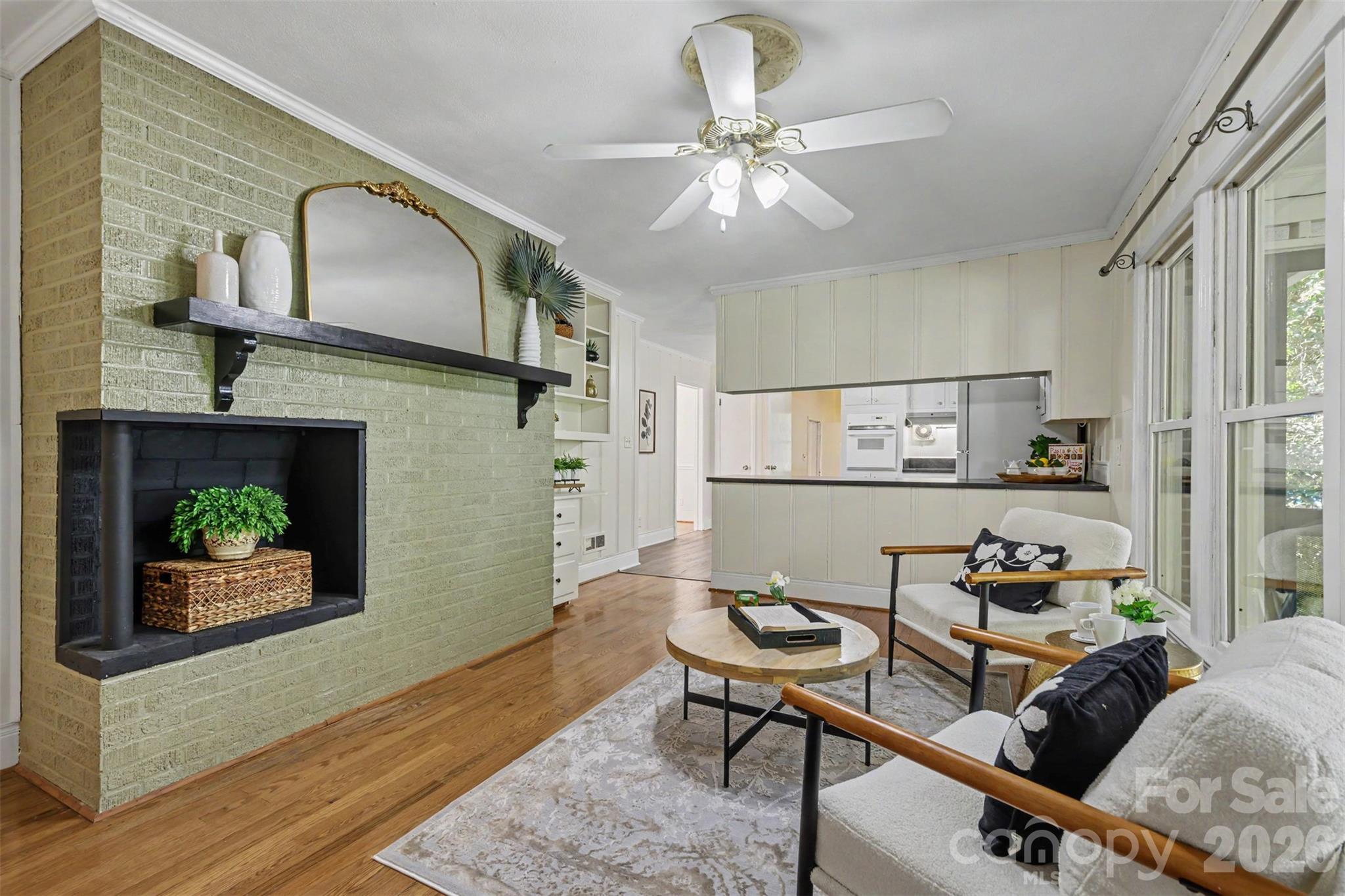 Old-fashioned charm meets everyday comfort. A decorative brick fireplace adds character to this inviting family room. - 407 Pine Street, Fort Mill