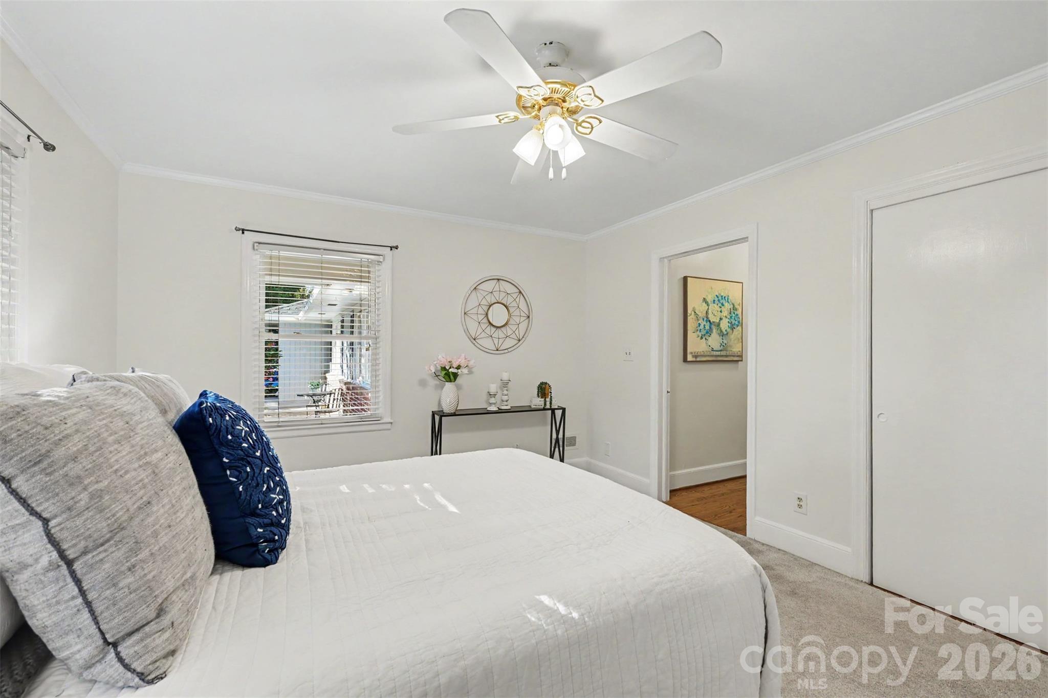 Another view of the primary bedroom highlights its generous proportions and flexible furniture arrangement. - 407 Pine Street, Fort Mill