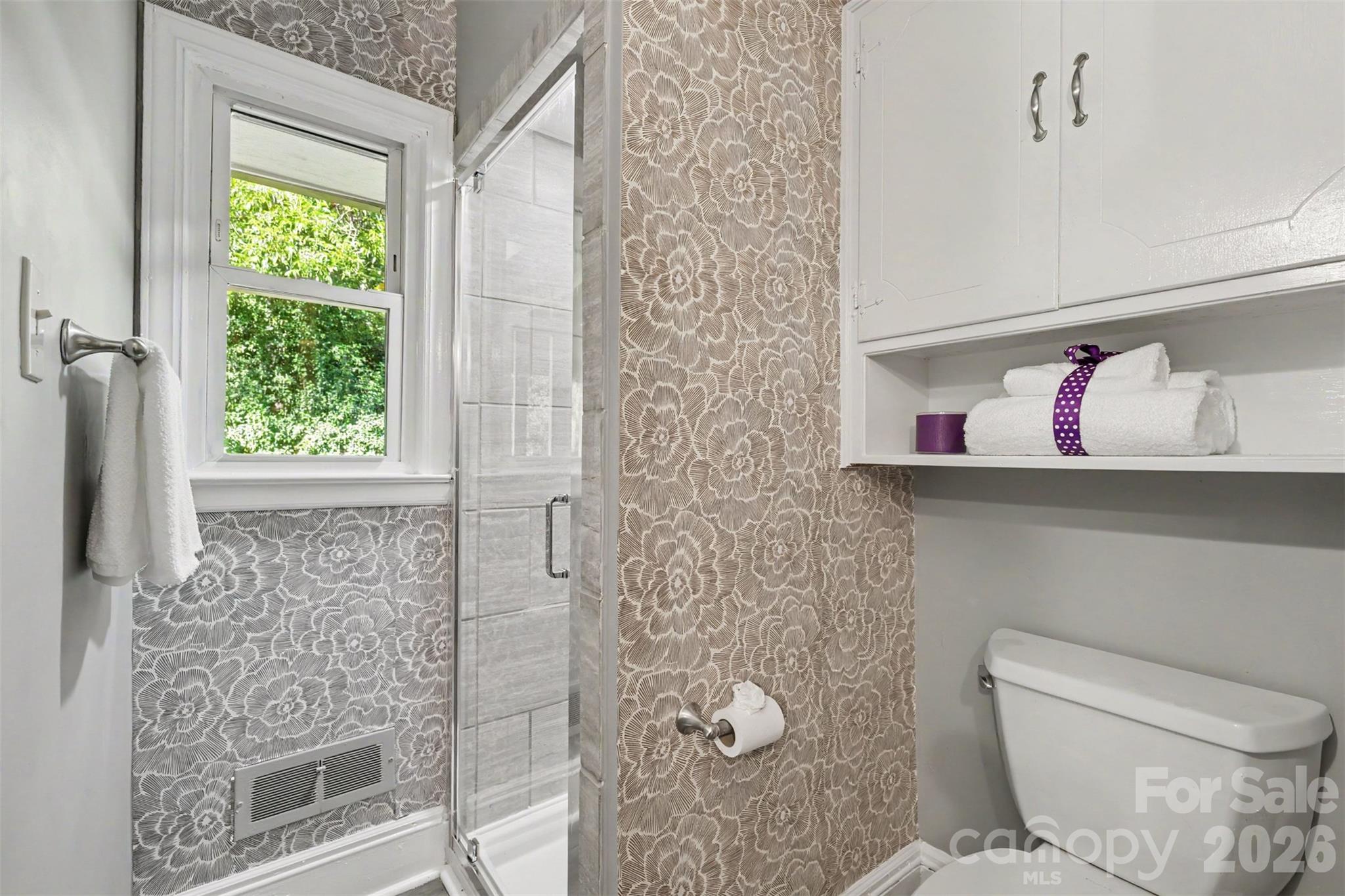 Second bathroom featuring a walk-in shower and built in cabinet. Conveniently located for guests and everyday use. - 407 Pine Street, Fort Mill