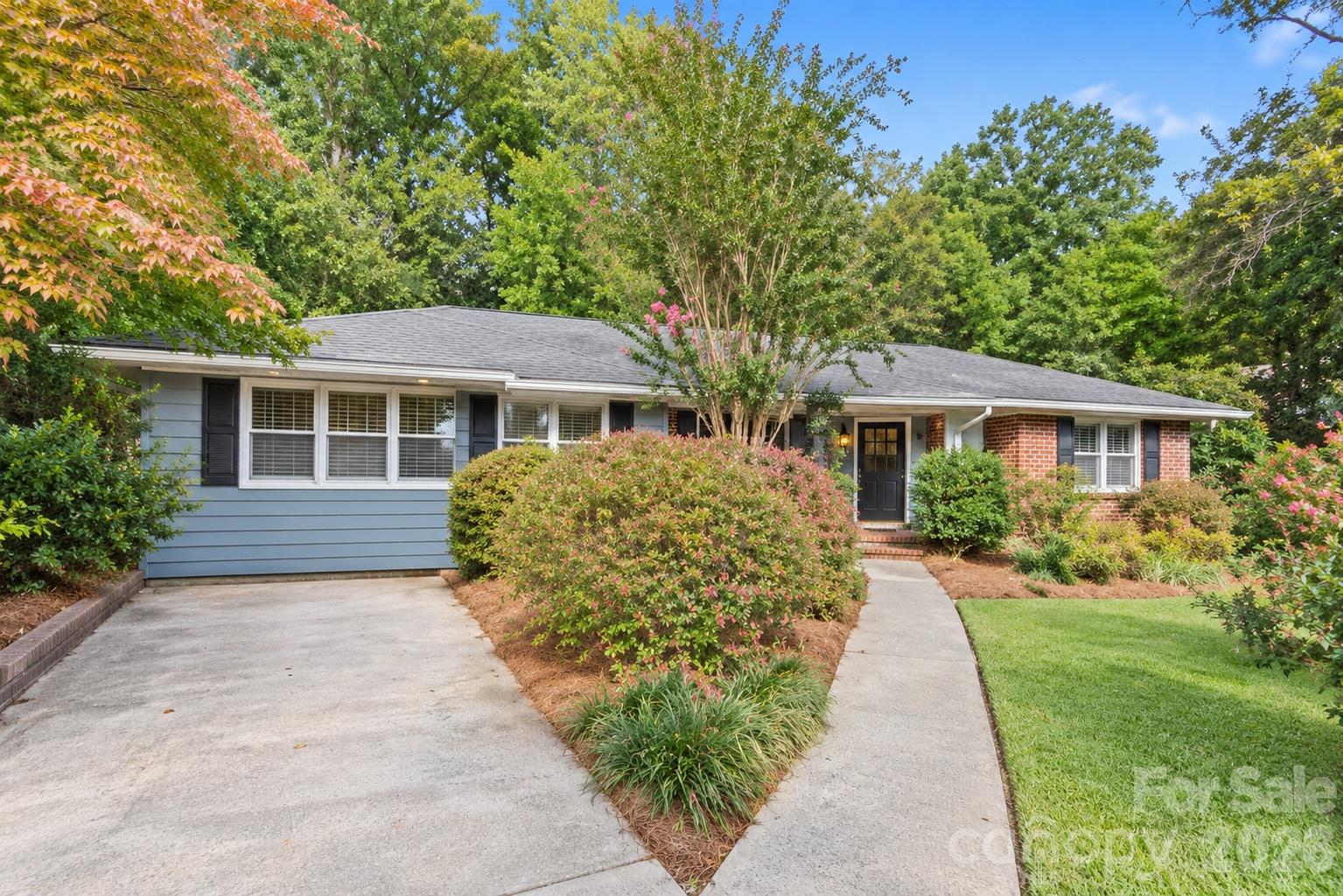 A welcoming approach to this classic brick ranch, surrounded by mature landscaping. - 407 Pine Street, Fort Mill