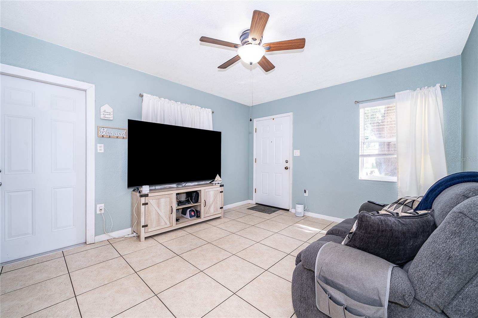 Make yourself at home in this comfortable living room, offering natural light and plenty of space to gather with family and friends. - 800 DORADO AVE, ORLANDO