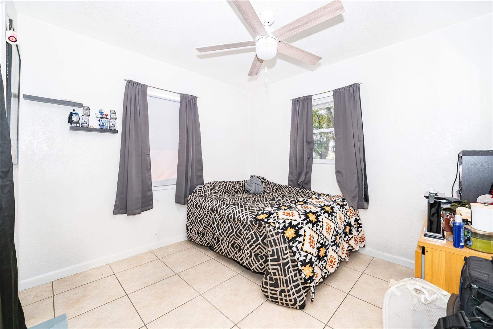A comfortable bedroom filled with natural light, offering a relaxing space to unwind and recharge. - 800 DORADO AVE, ORLANDO