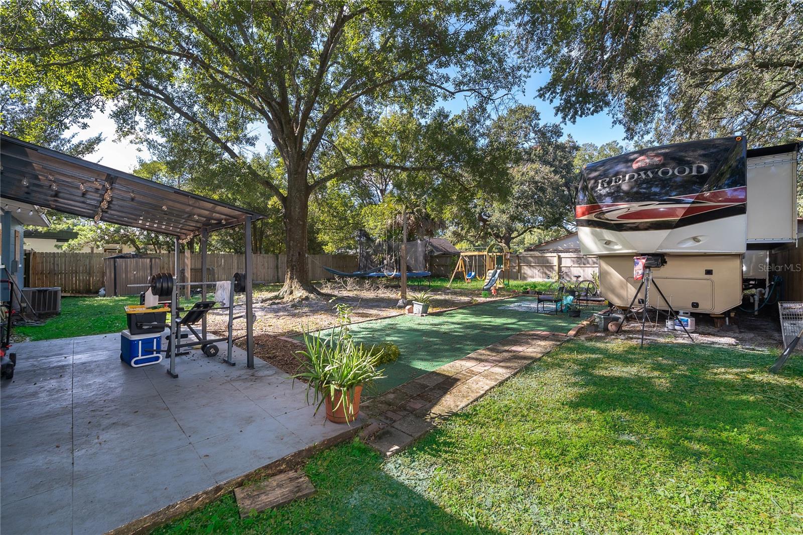Step outside and discover a spacious backyard with mature trees, a patio area, and plenty of room to enjoy the outdoors. - 800 DORADO AVE, ORLANDO