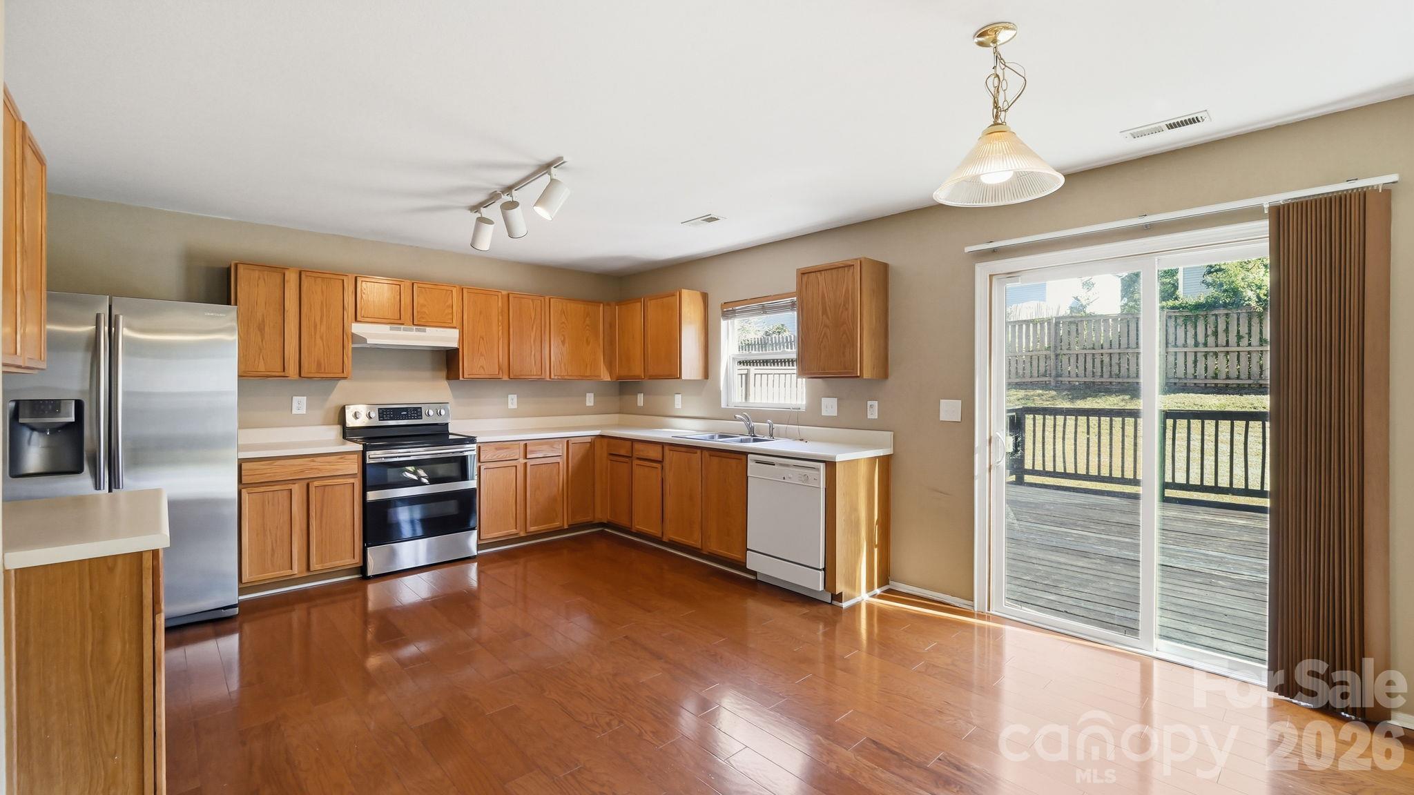 Kitchen and Breakfast Area overlooking Enlarged Deck and Backyard - 2806 Buckleigh Drive, Charlotte