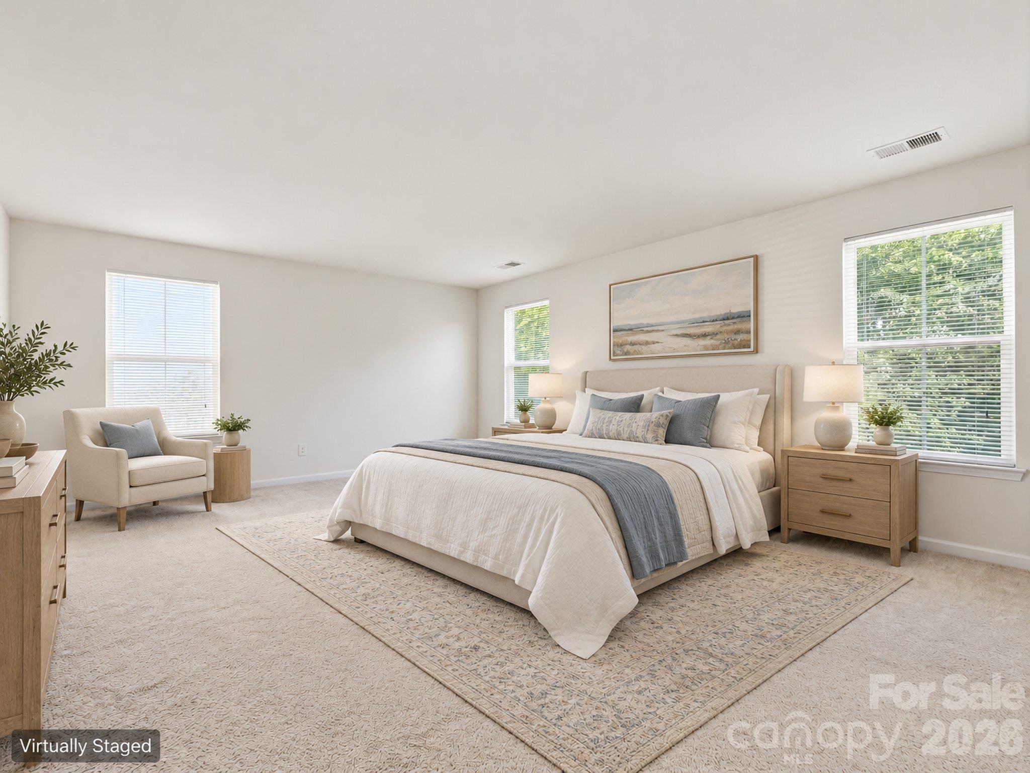 Virtually staged primary bedroom illustrates a sleeping area and sitting space. Furnishings and décor digitally added. - 3341 Linetender Drive, Davidson