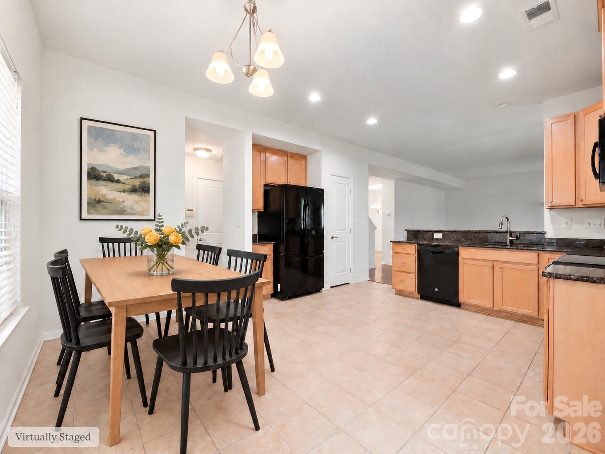 Virtually staged casual dining area beside the kitchen illustrates space for everyday meals, with sliding-door access to the backyard patio. Furnishings and décor digitally added. - 3341 Linetender Drive, Davidson