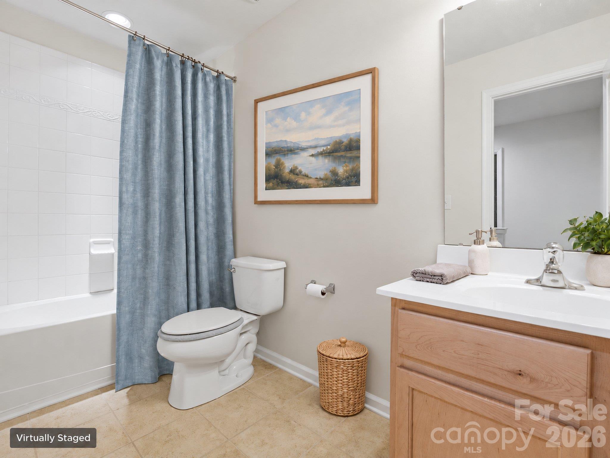 Upstairs full bath - virtually staged: Tub/shower combination and vanity storage. Shower curtain, artwork, and accessories digitally added. An unstaged view is also provided. - 3341 Linetender Drive, Davidson