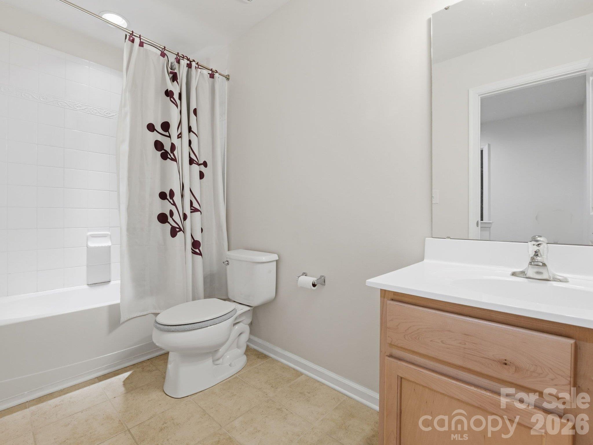 Upstairs full bath: Unstaged view showing the tub/shower combination, vanity storage, and existing finishes. - 3341 Linetender Drive, Davidson