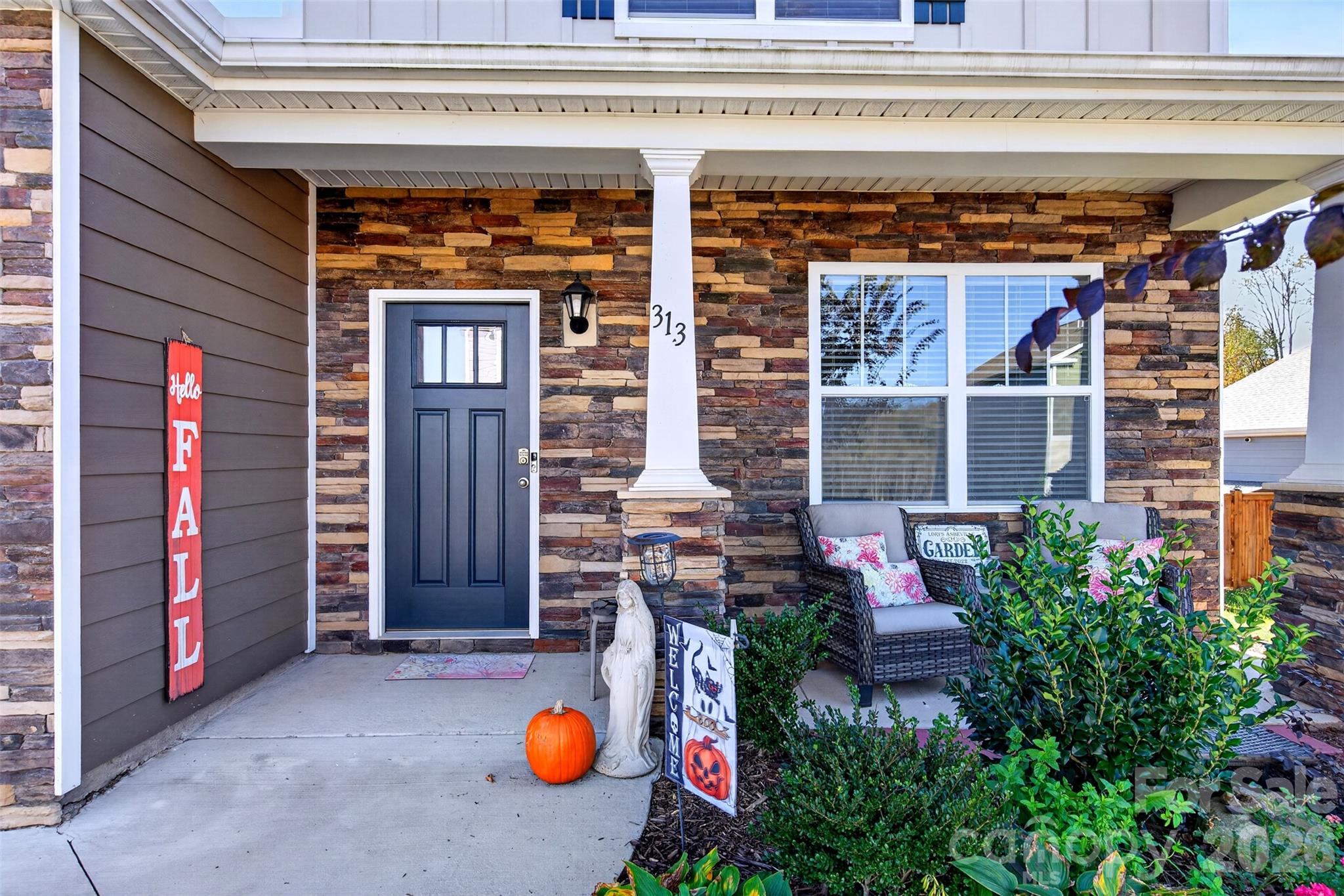The inviting front porch is the perfect place to relax and enjoy the beautiful views. - 313 Tavernier Lane, Candler