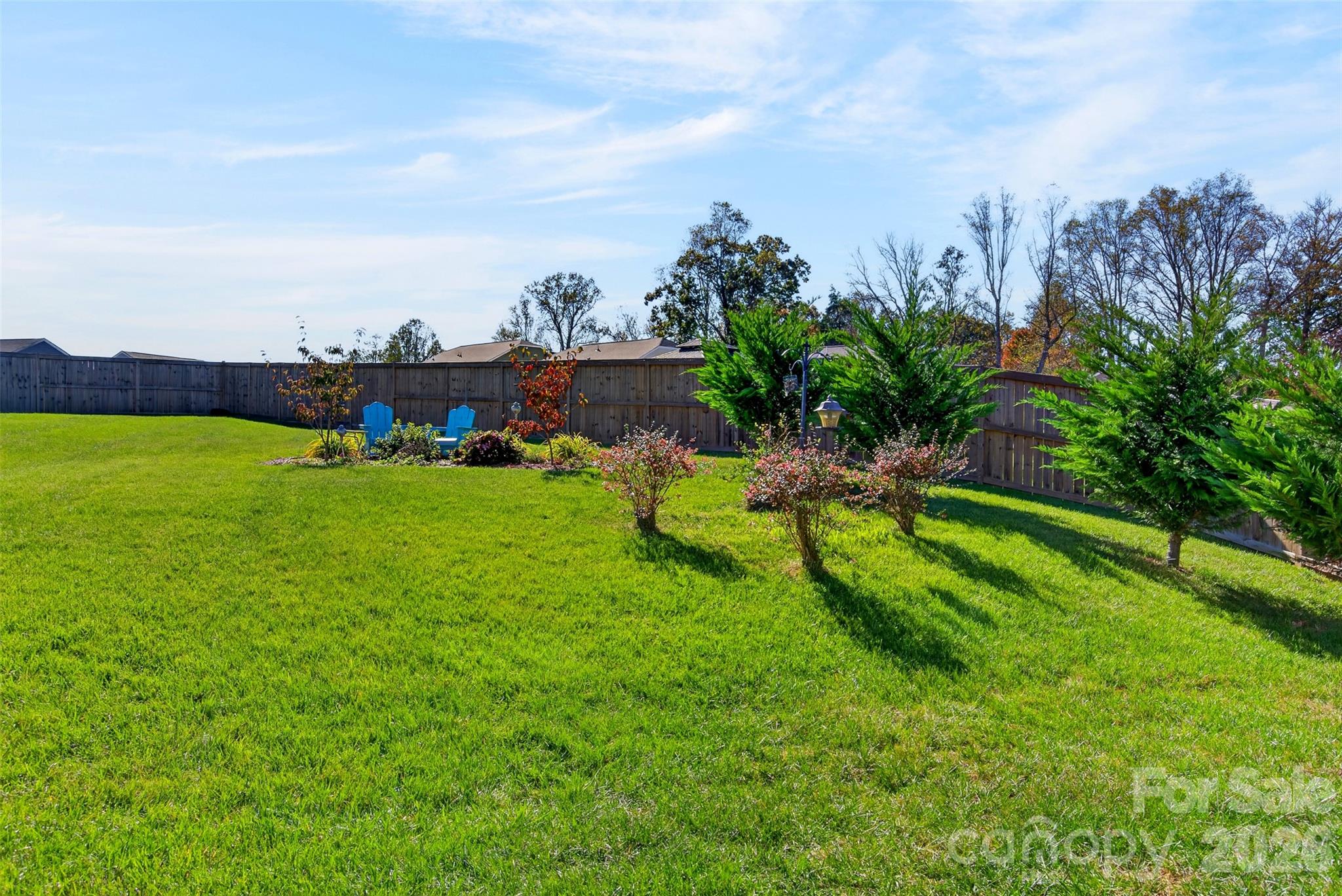 Enjoy the spacious, level backyard—perfect for gardening, grilling, outdoor entertaining, and creating your own private outdoor retreat. - 313 Tavernier Lane, Candler