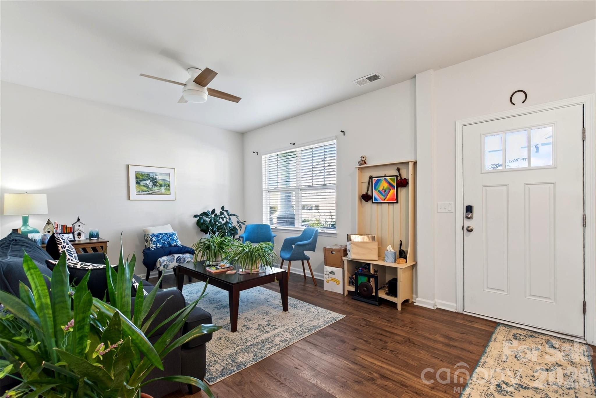 A cozy sitting room welcomes you as you enter the home, offering a warm and inviting space to relax or the flexibility to use as a dining room. - 313 Tavernier Lane, Candler