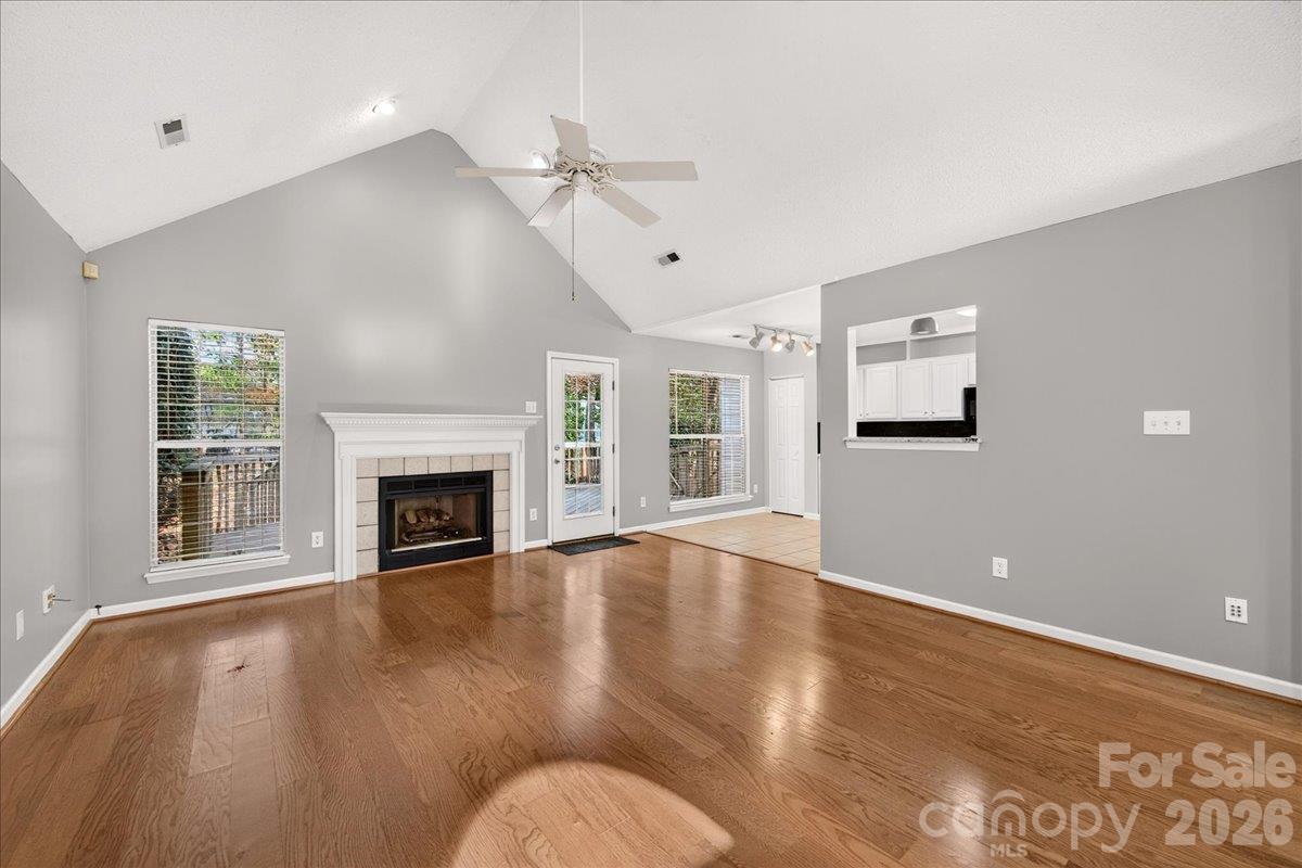 Living Room open concept with laminate hardwood flooring gas fireplace - 9115 Pine Springs Court, Huntersville