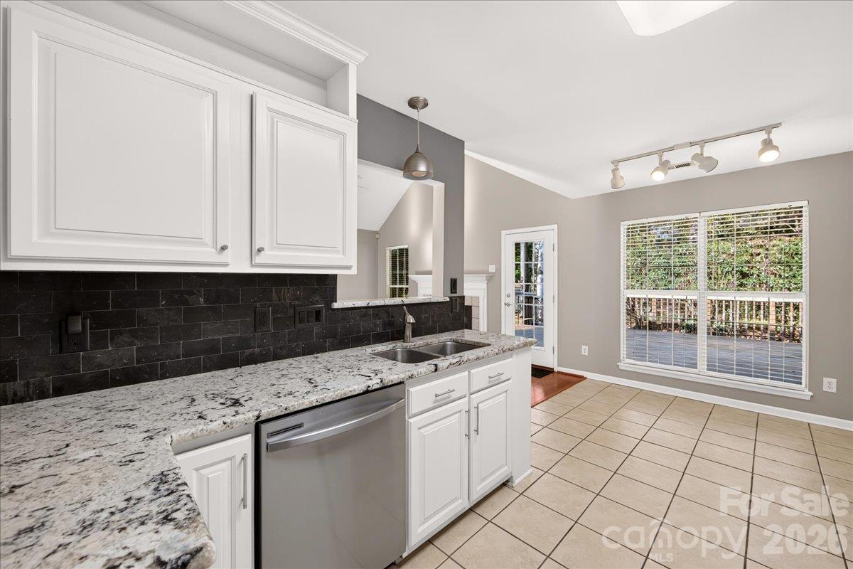 Kitchen with opening into living room and cut out see through at the sink - 9115 Pine Springs Court, Huntersville