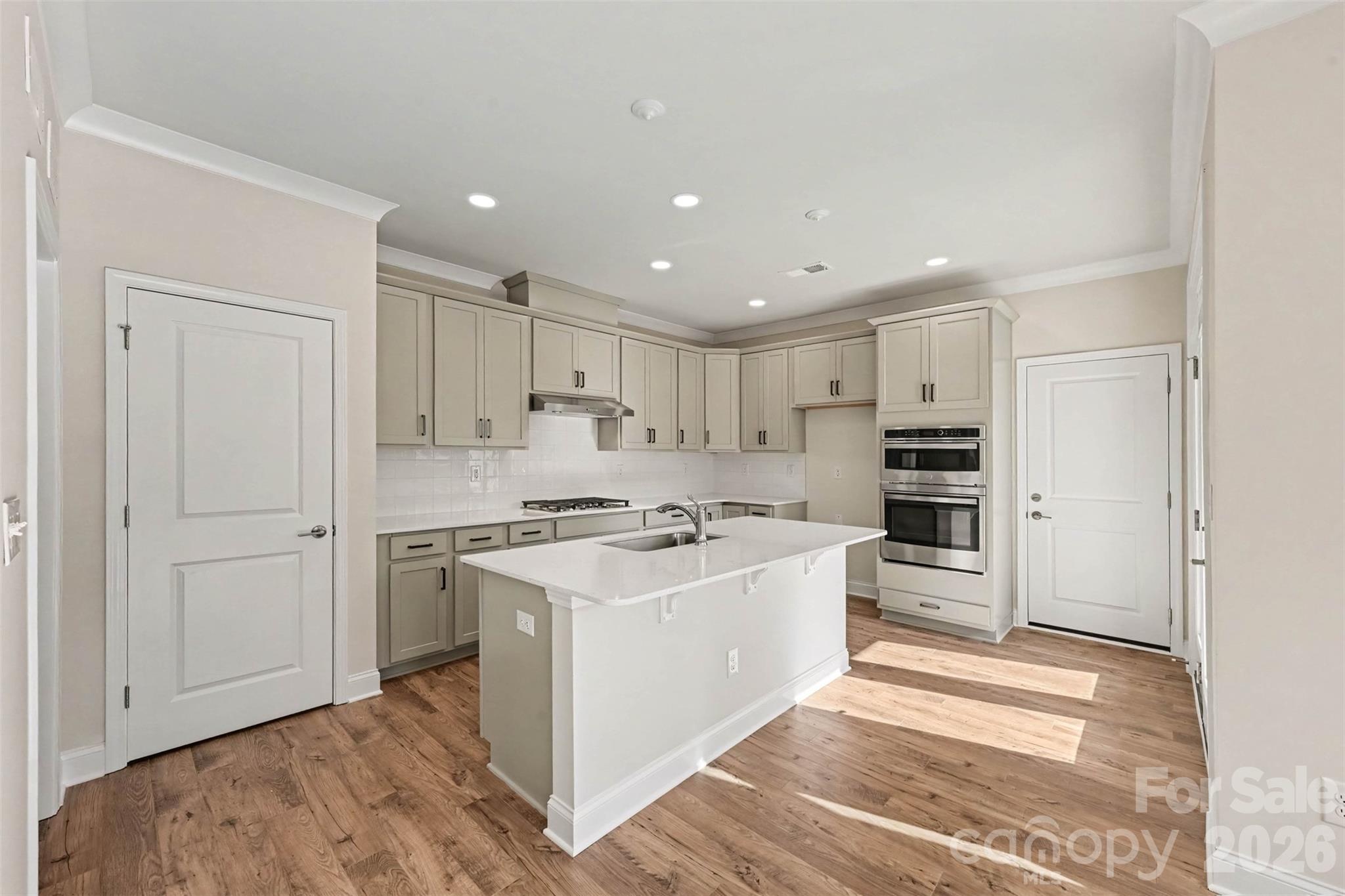 Biscuit cabinets with white quartz counters - 10225 Rainier Trail Drive NW, Huntersville