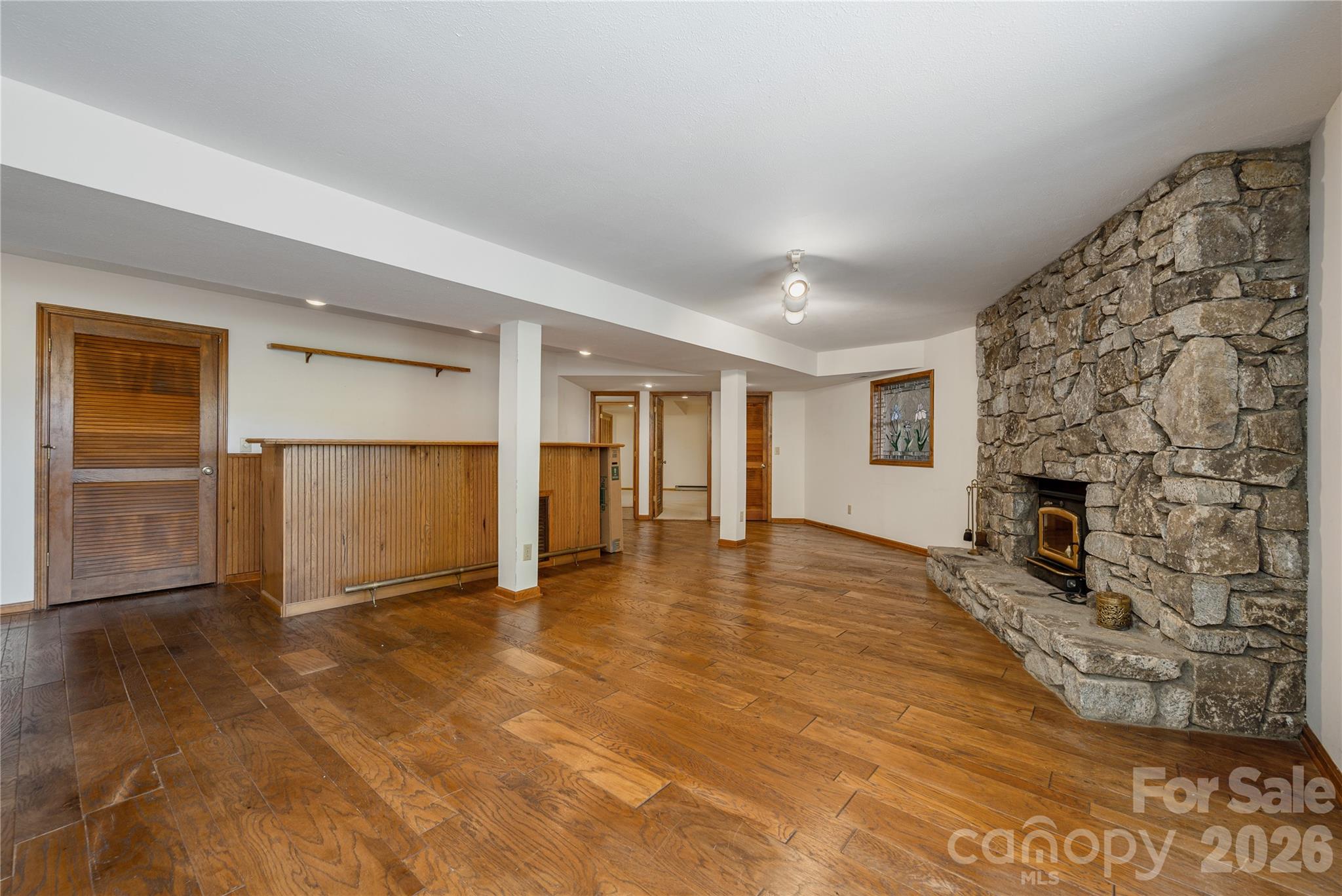 Downstairs living area- w/ wood stove - 20 Wild Cherry Drive, Mills River