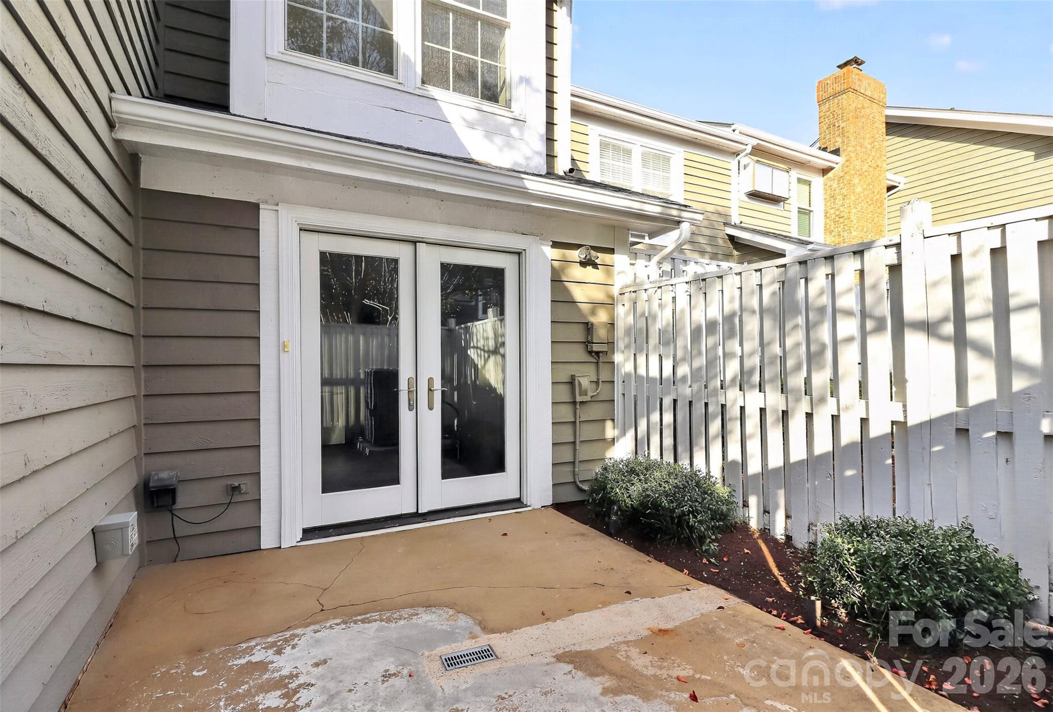 Side patio leads into kitchen - 8254 Tradd Court, Charlotte