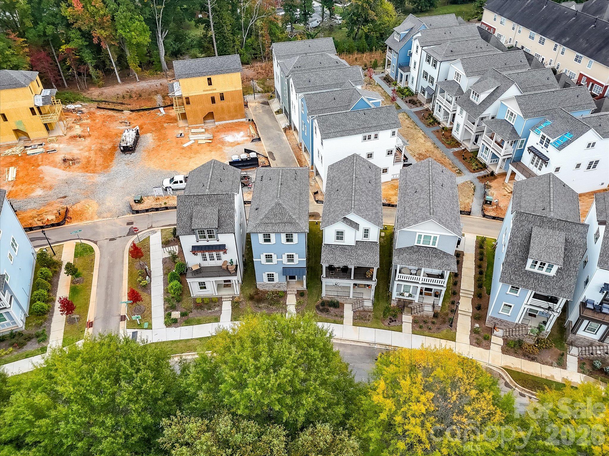 Aerial view showcasing the charming three-story home nestled among attractive neighboring residences in a beautifully landscaped community. - 225 Davidson Gateway Drive, Davidson