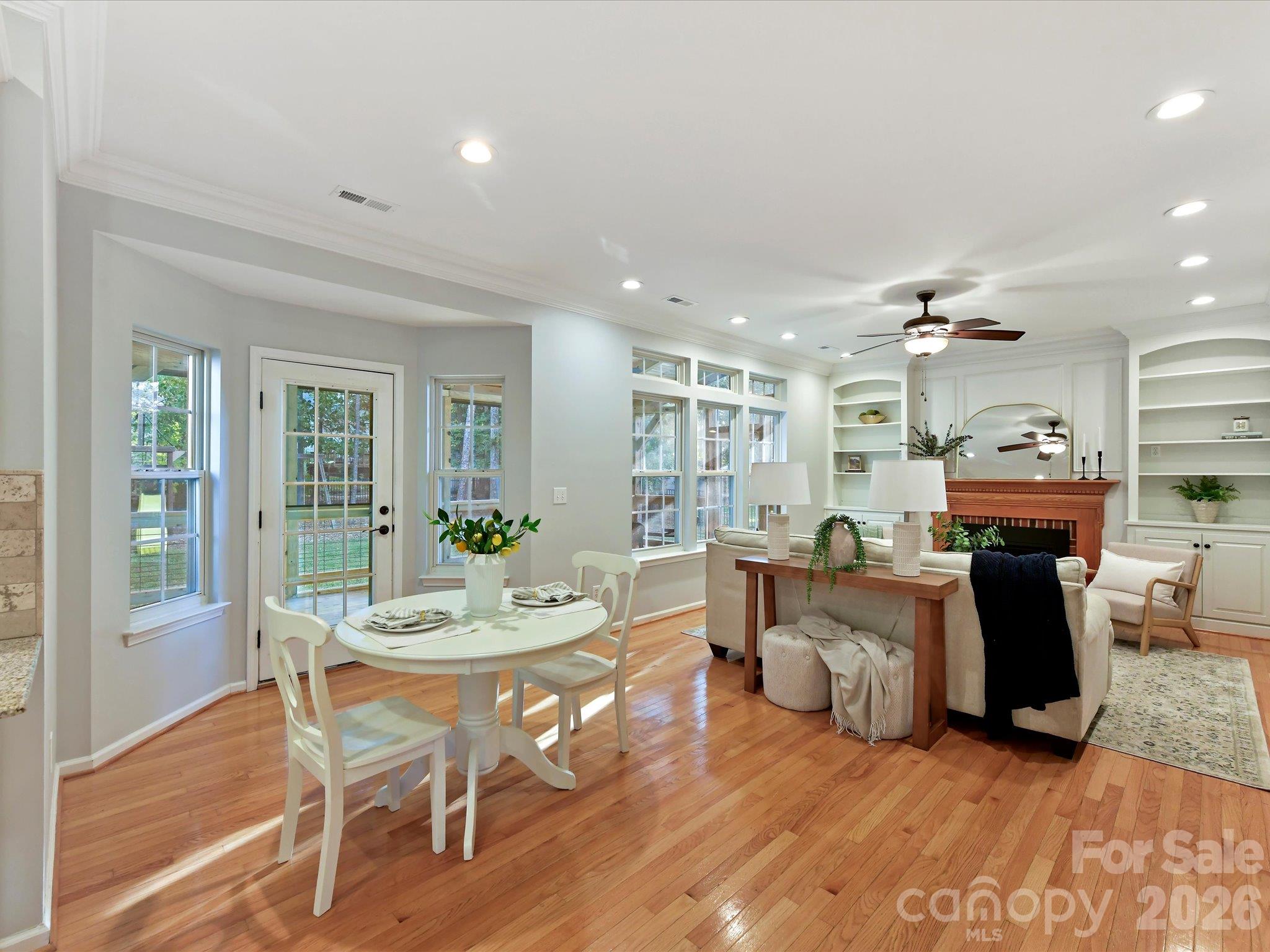 Bright breakfast nook featuring beautiful hardwood floors, abundant natural light, and an open flow into the inviting great room. - 3819 Waters Reach Lane, Indian Trail