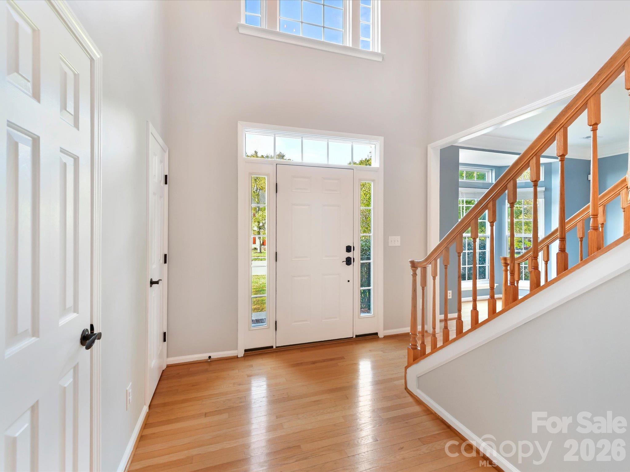 Beautiful staircase featuring warm wood railings, carpeted steps, and an open design connecting the main living areas. - 3819 Waters Reach Lane, Indian Trail